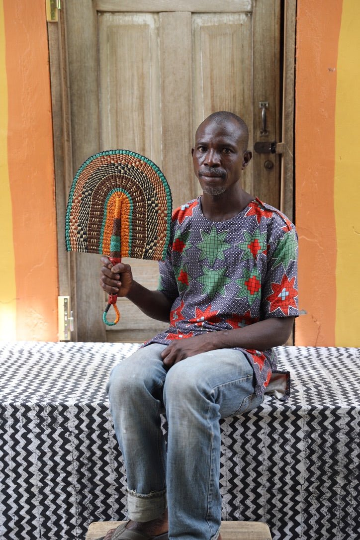 The Baba Tree Bolga Original Fan: Handwoven architectural wall art with intricate weave and premium leather handle.