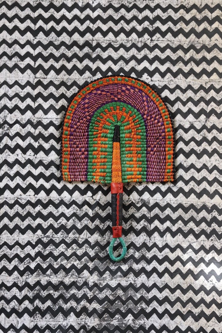 The Baba Tree Bolga Original Fan: Handwoven architectural wall art with intricate weave and premium leather handle.