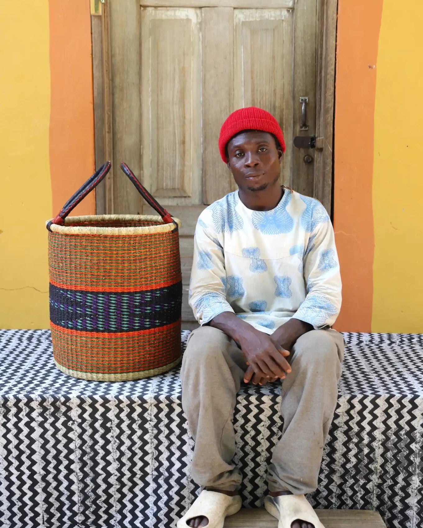 Open Laundry Basket (Small) by The Baba Tree. Handwoven elephant grass storage with leather handles. Bolgatanga artisan decor.