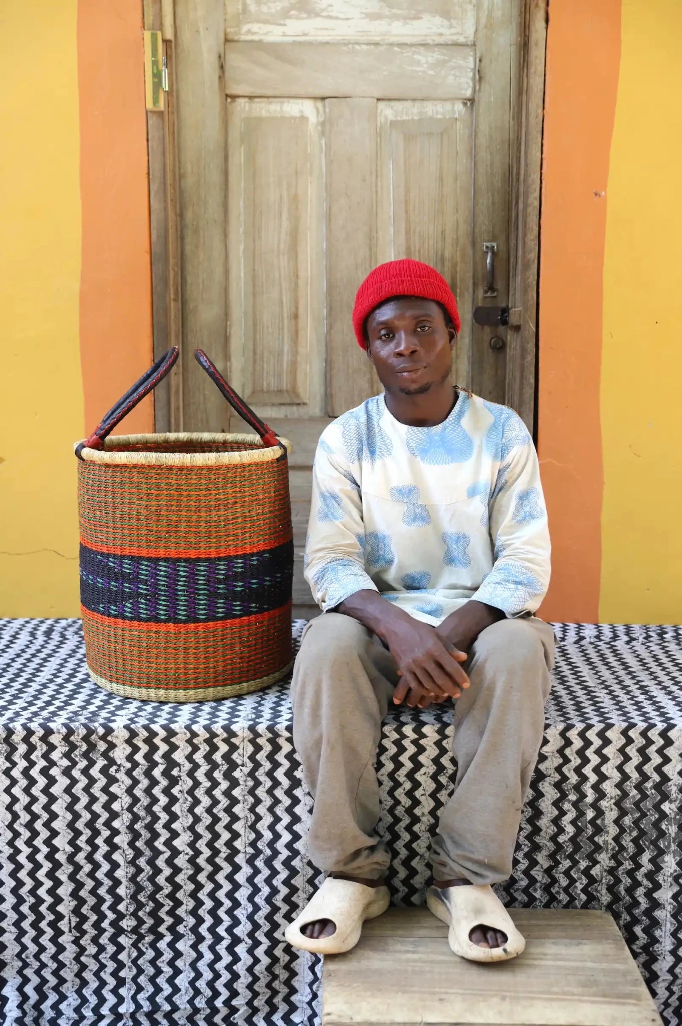 Open Laundry Basket (Small) by The Baba Tree. Handwoven elephant grass storage with leather handles. Bolgatanga artisan decor.