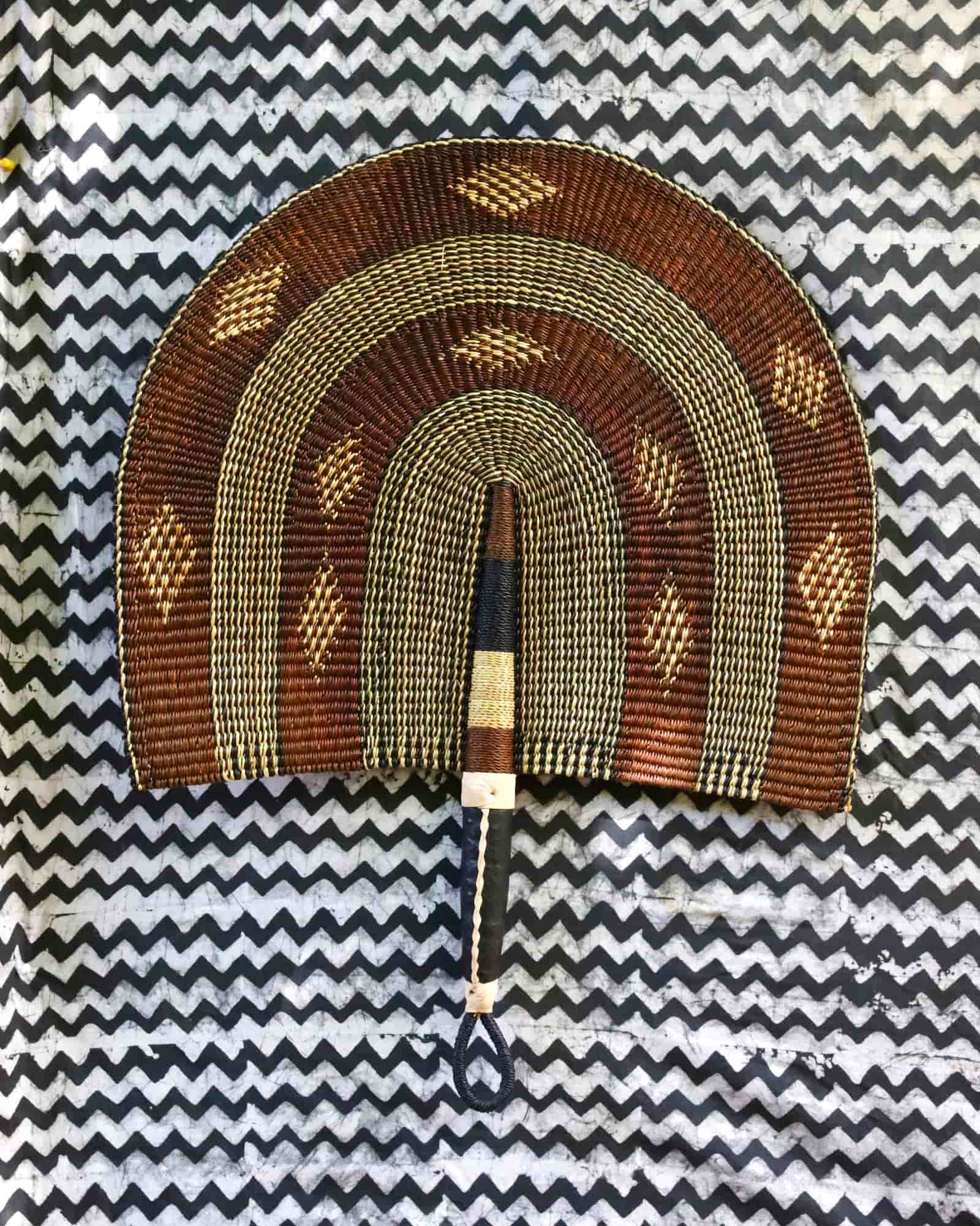 Naba Penga wall décor: brown and cream rainbow arch with diamond motifs, flat lay
