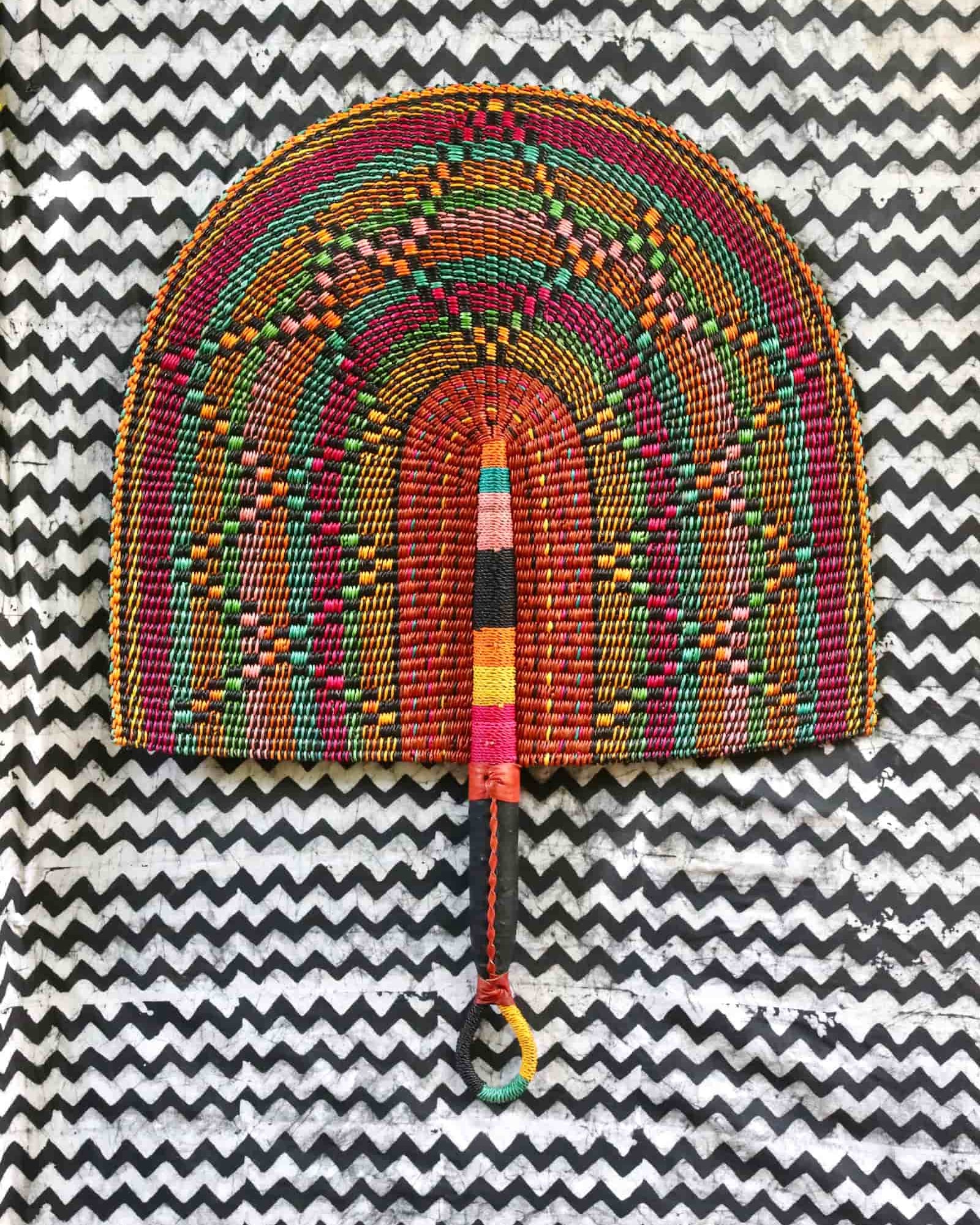 Naba Penga wall décor: burgundy rainbow arch with multicolour spot pattern, flat lay