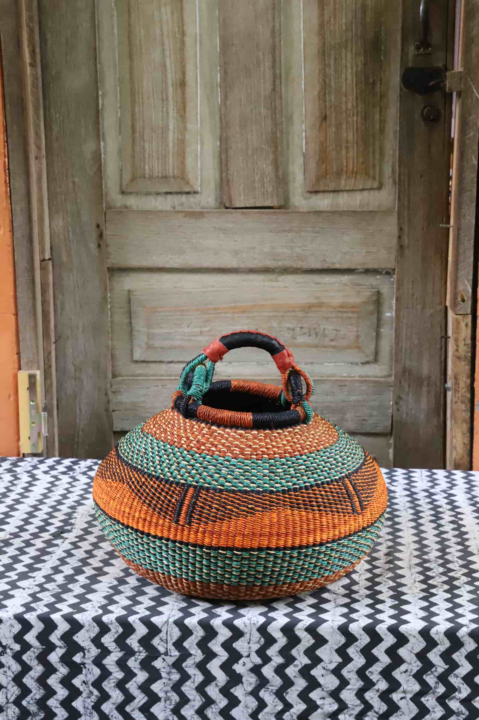 Large pot storage basket in burnt orange and teal bands with black geometric detail