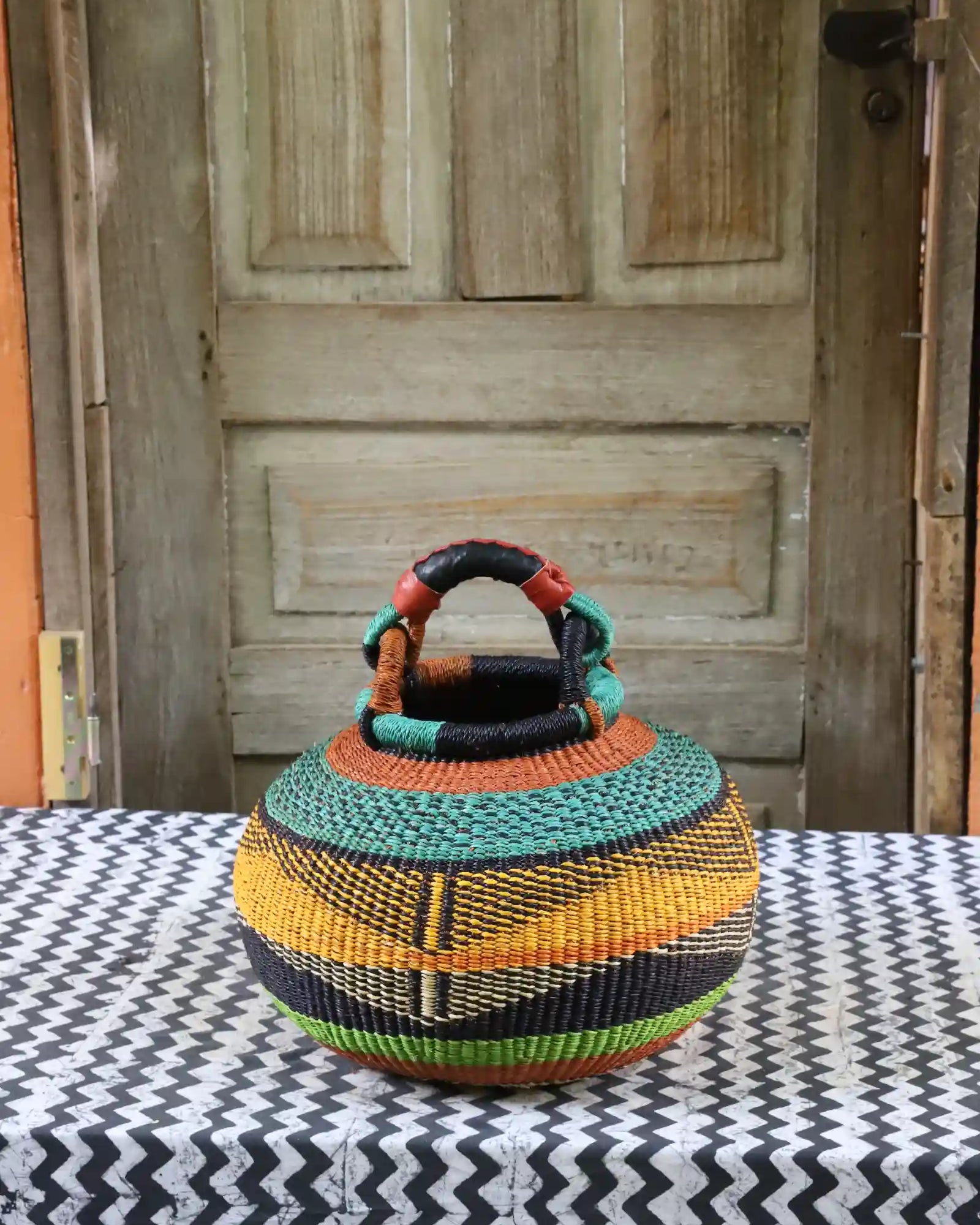 Small pot storage basket with teal dome and black, yellow and lime green body