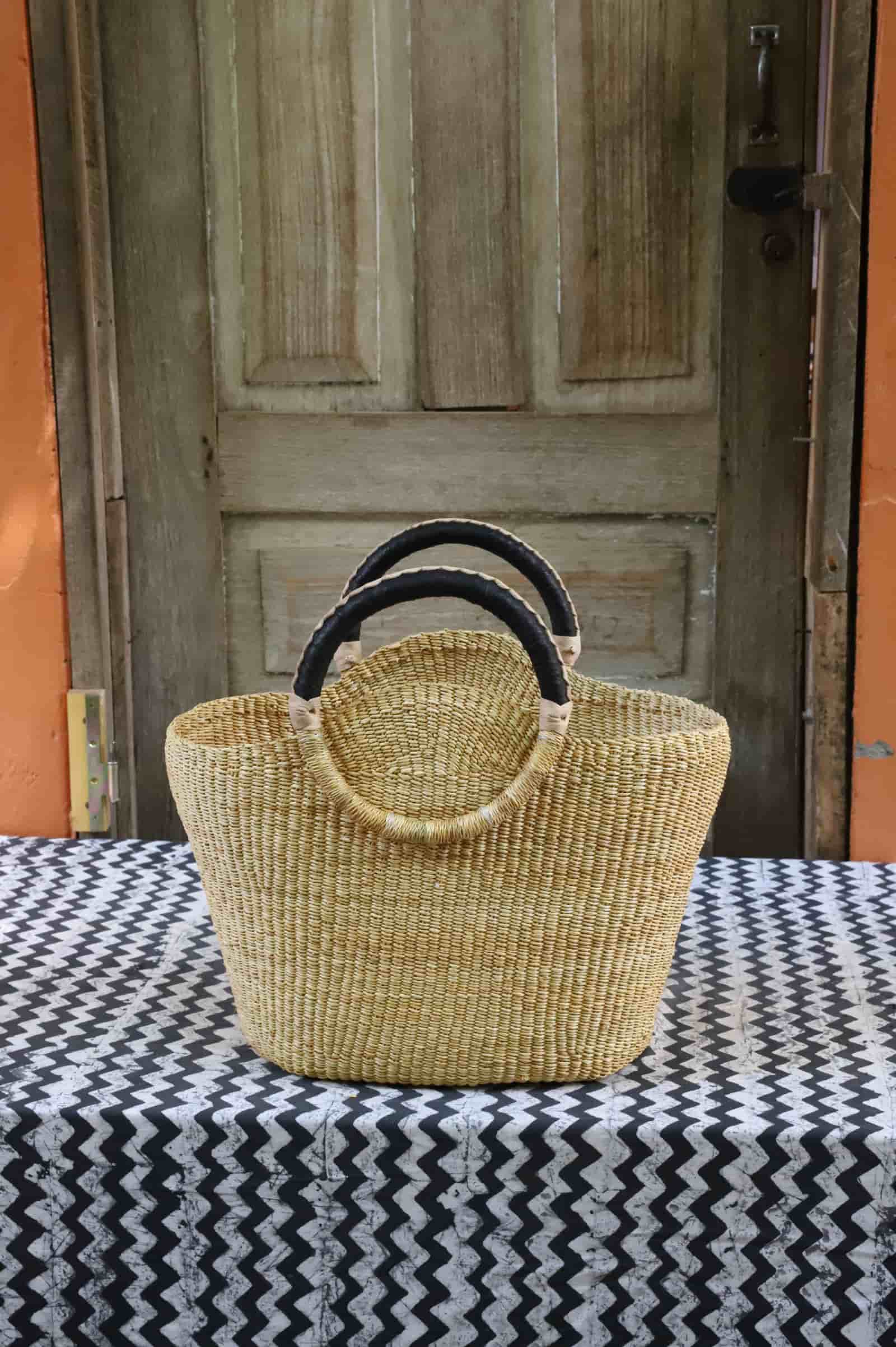 Naughty George weekend bag in natural straw with black leather loop handles, front view