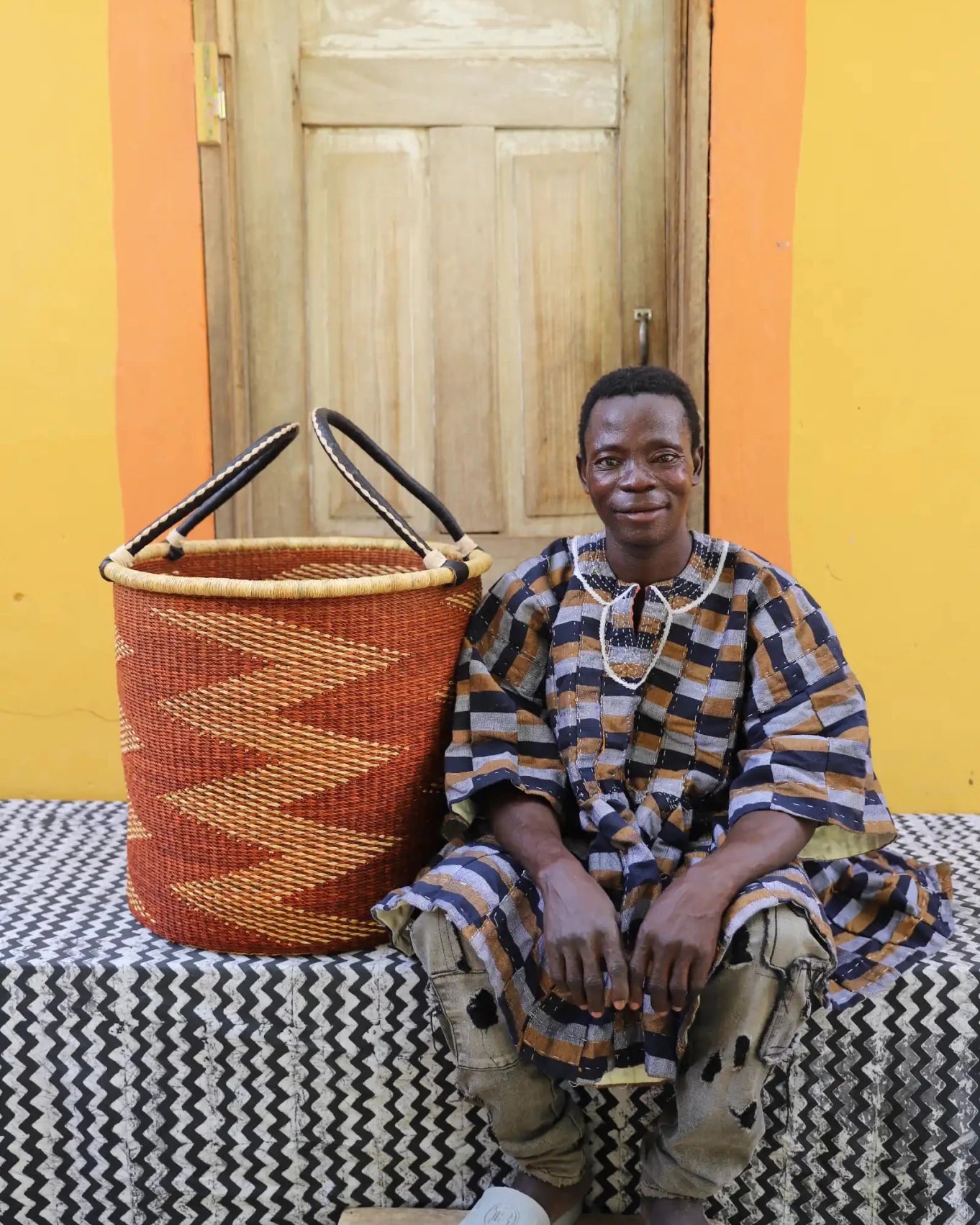 Open Laundry Basket (Large) by The Baba Tree. Handwoven elephant grass storage with leather handles. Bolgatanga artisan decor.