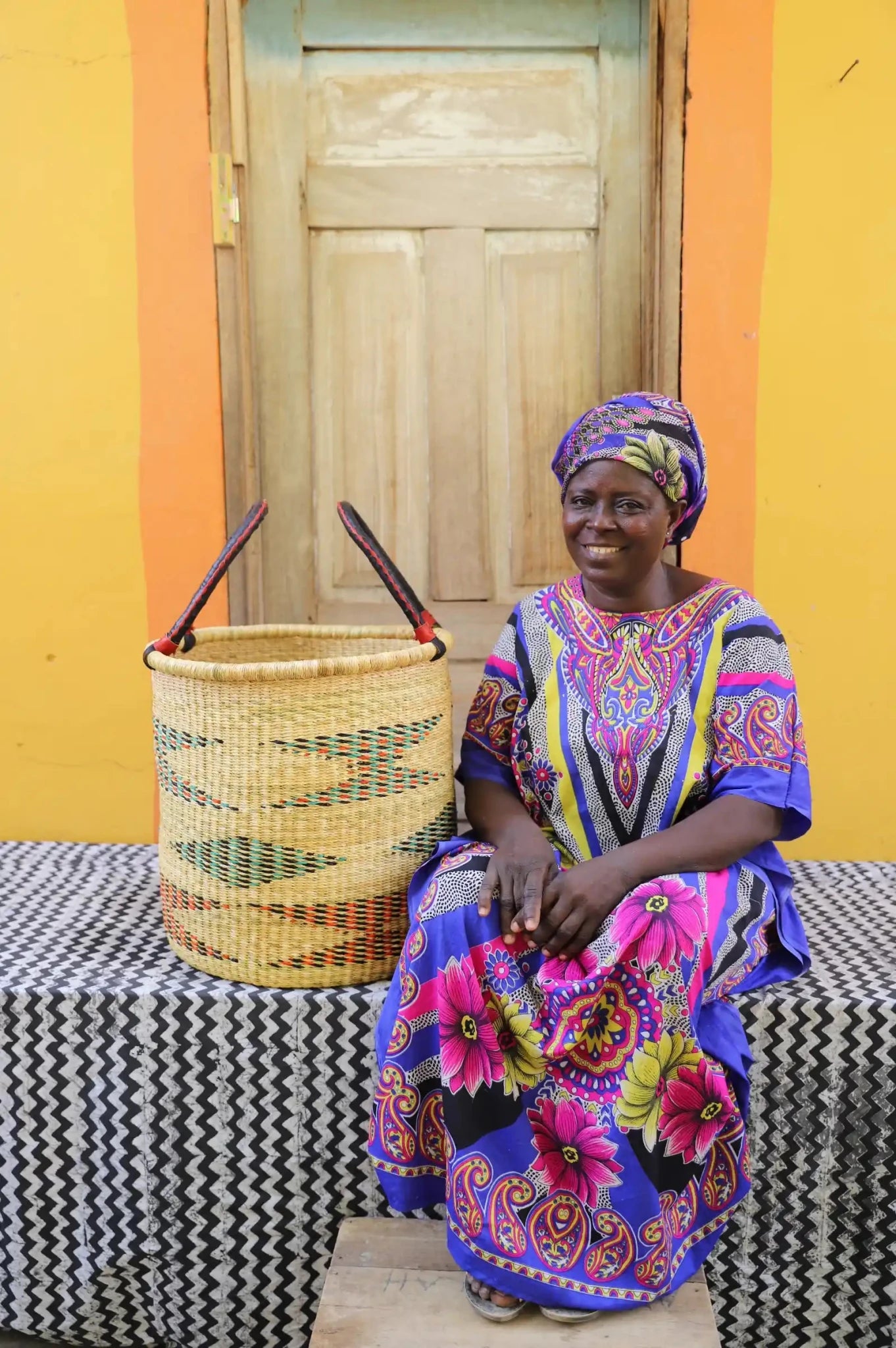 Open Laundry Basket (Medium) by The Baba Tree. Handwoven elephant grass storage with leather handles. Bolgatanga artisan decor.