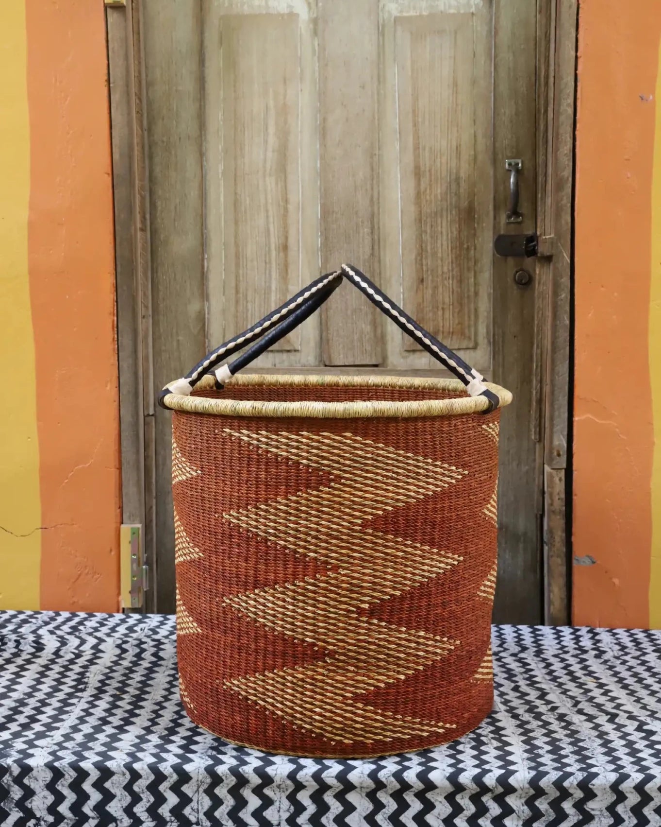 Open Laundry Basket (Large) by The Baba Tree. Handwoven elephant grass storage with leather handles. Bolgatanga artisan decor.