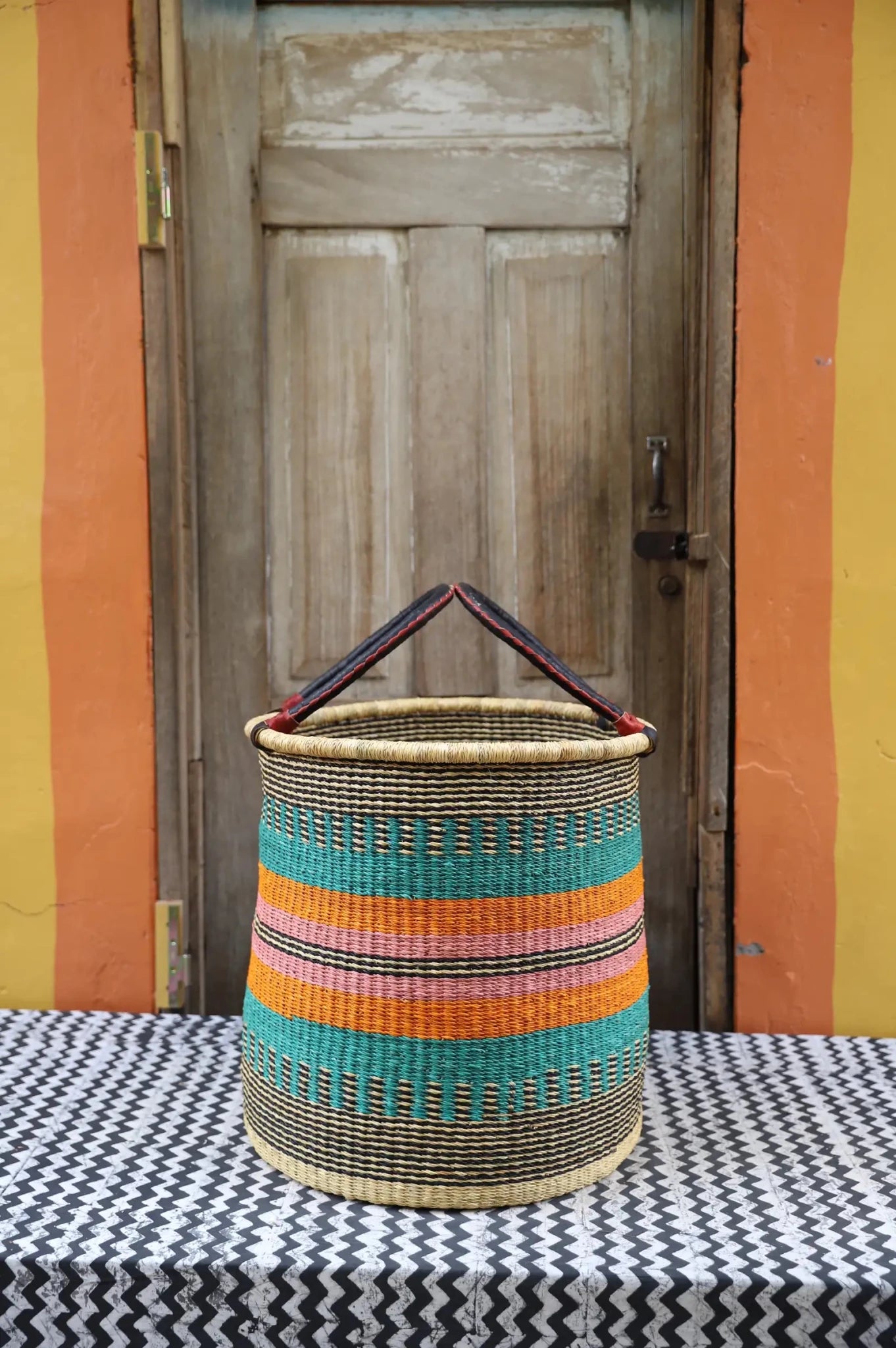 Open Laundry Basket (Large) by The Baba Tree. Handwoven elephant grass storage with leather handles. Bolgatanga artisan decor.