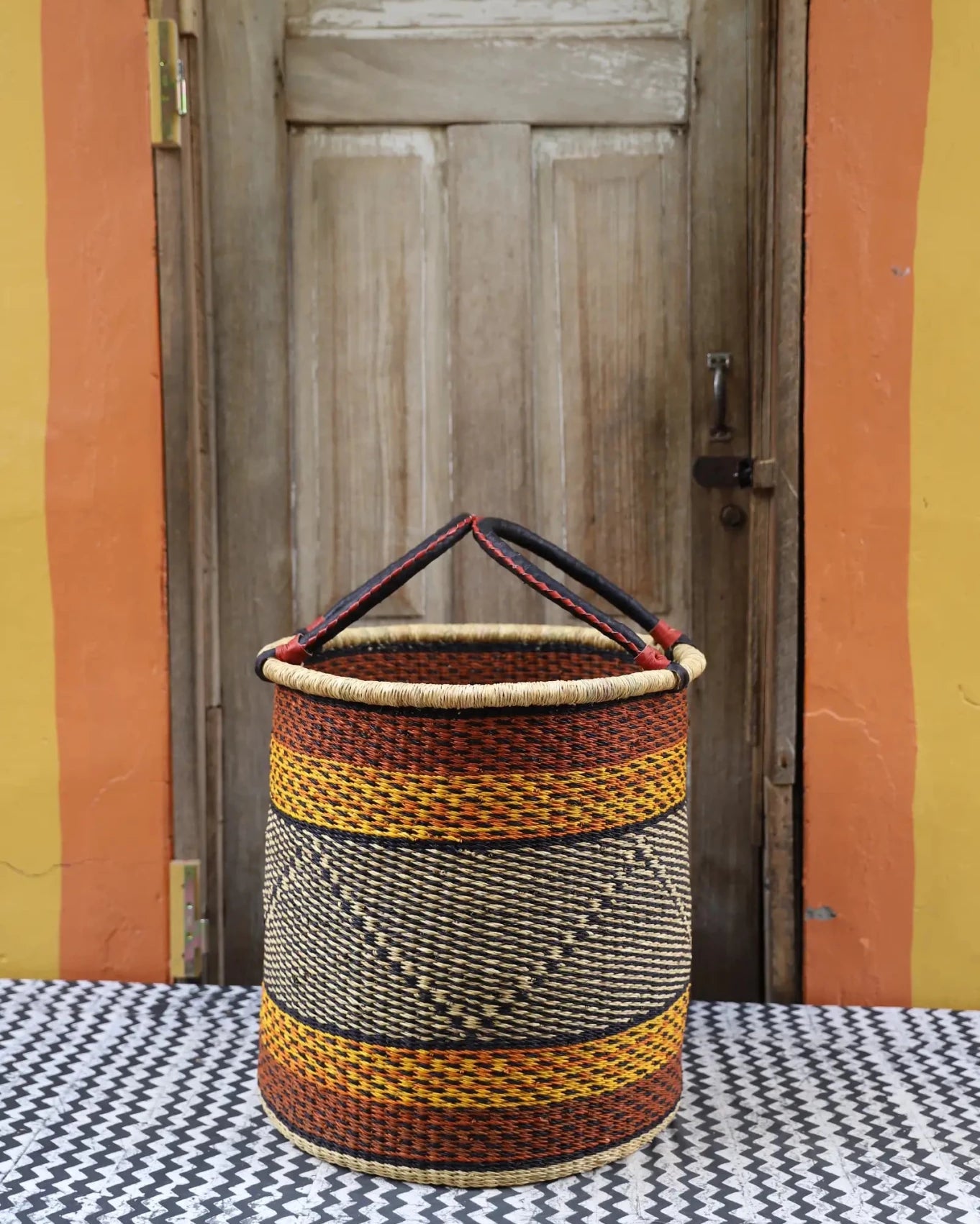 Open Laundry Basket (Large) by The Baba Tree. Handwoven elephant grass storage with leather handles. Bolgatanga artisan decor.