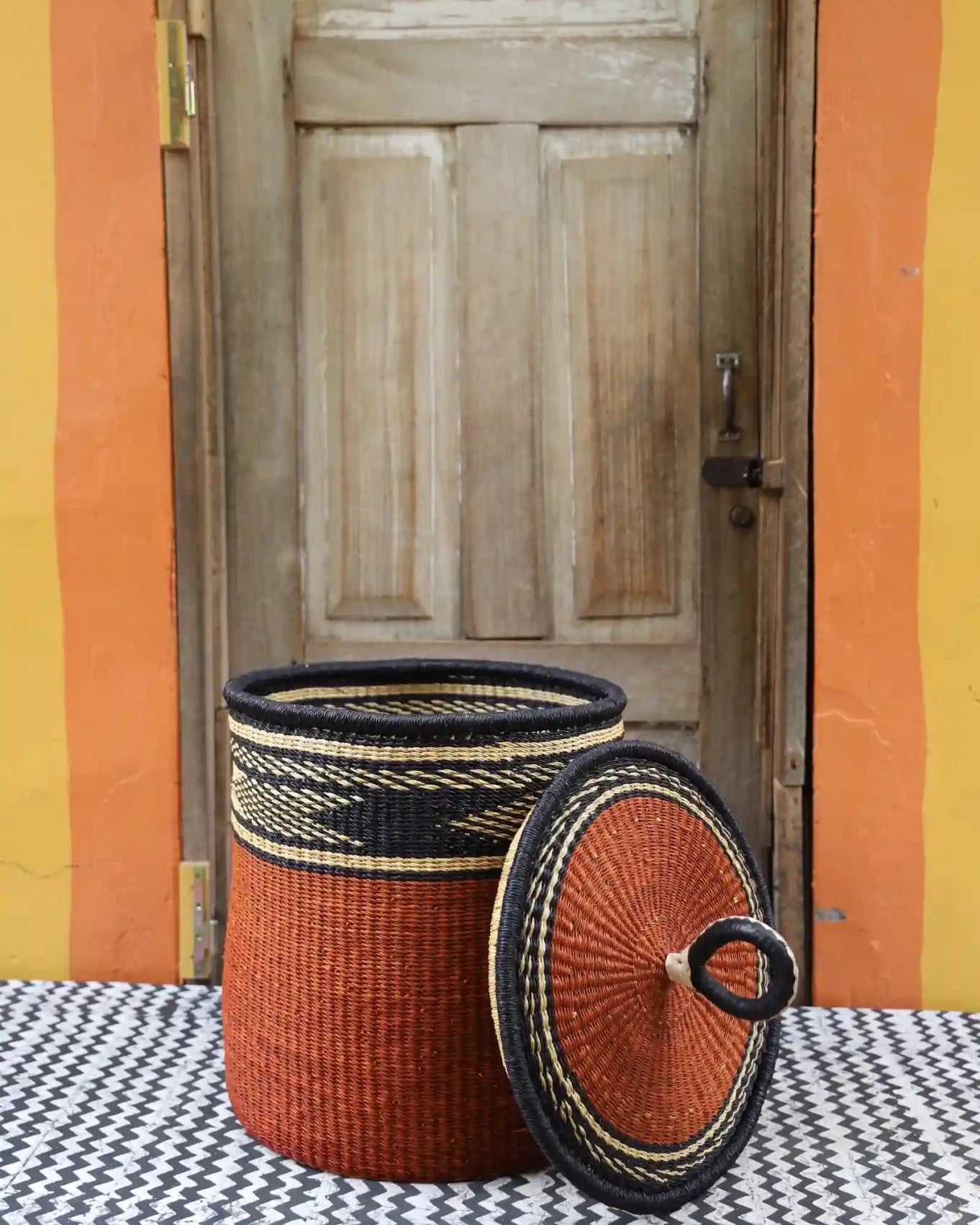 Lidded Laundry Basket with coil (Medium) by The Baba Tree. Handwoven elephant grass with leather handle. Premium Bolgatanga artisan decor.