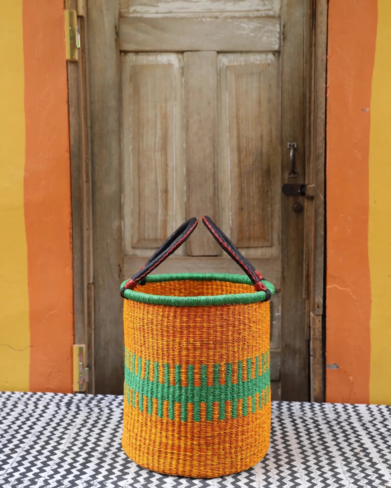 Open Laundry Basket (Small) by The Baba Tree. Handwoven elephant grass storage with leather handles. Bolgatanga artisan decor.