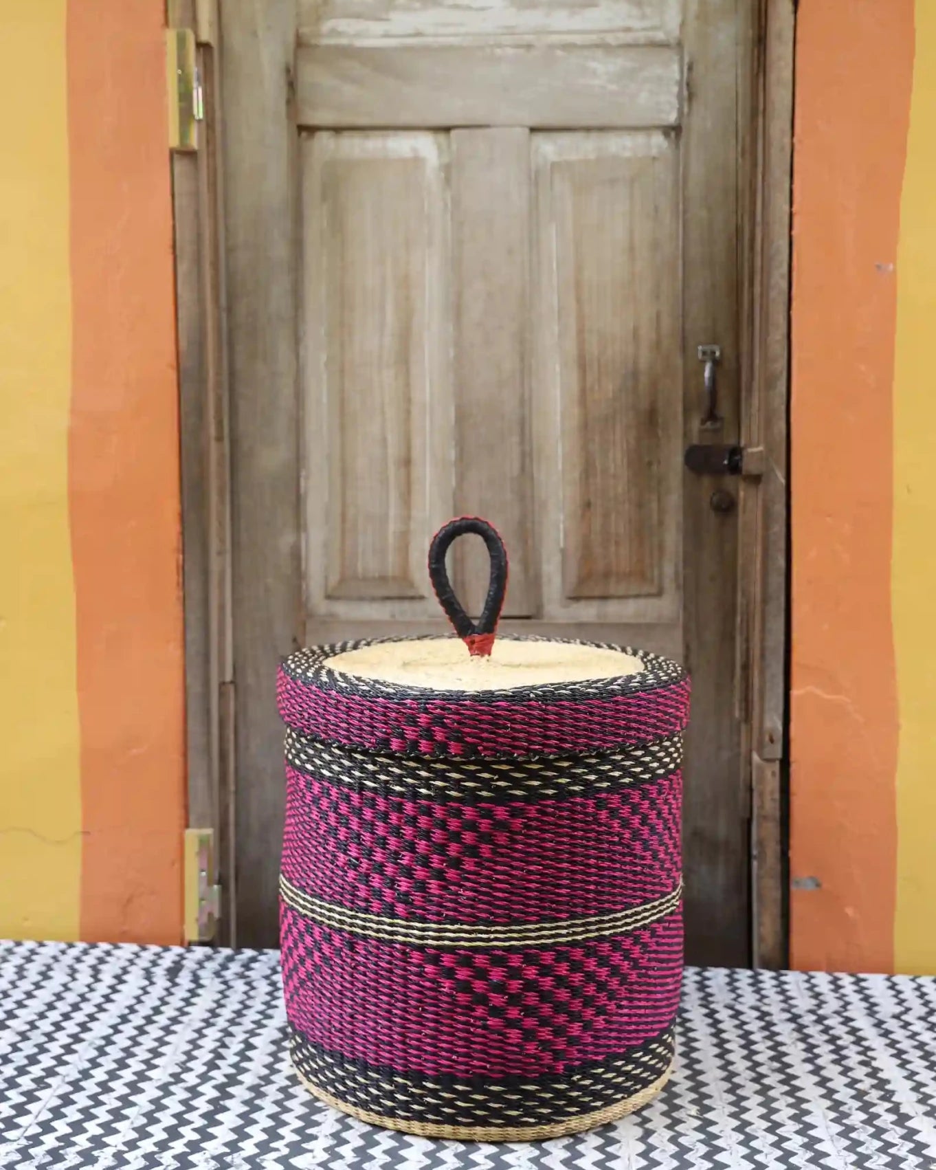 Lidded Laundry Basket (Medium) by The Baba Tree. Handwoven elephant grass with leather handle. Premium Bolgatanga artisan decor.l