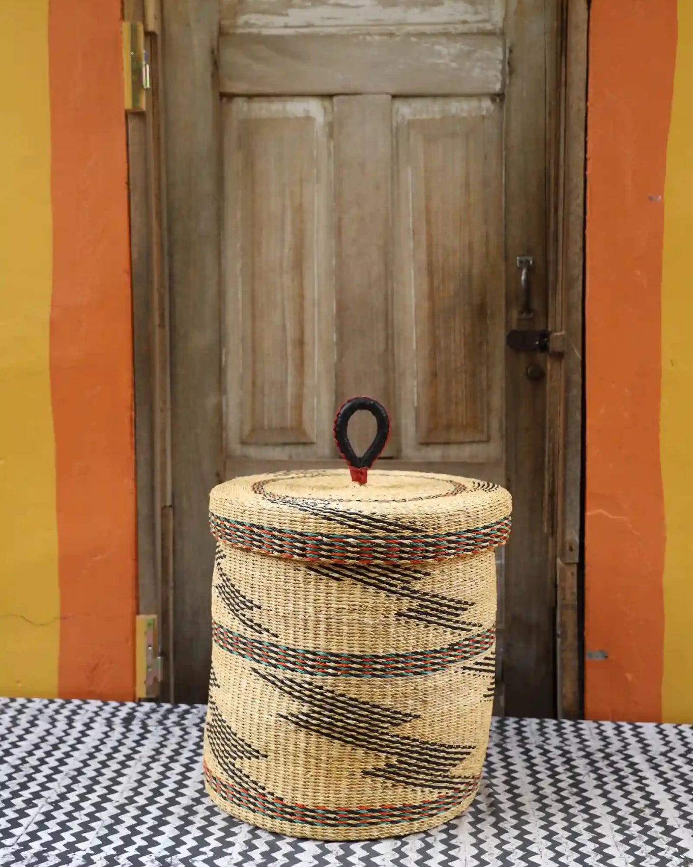 Lidded Laundry Basket (Medium) by The Baba Tree. Handwoven elephant grass with leather handle. Premium Bolgatanga artisan decor.l