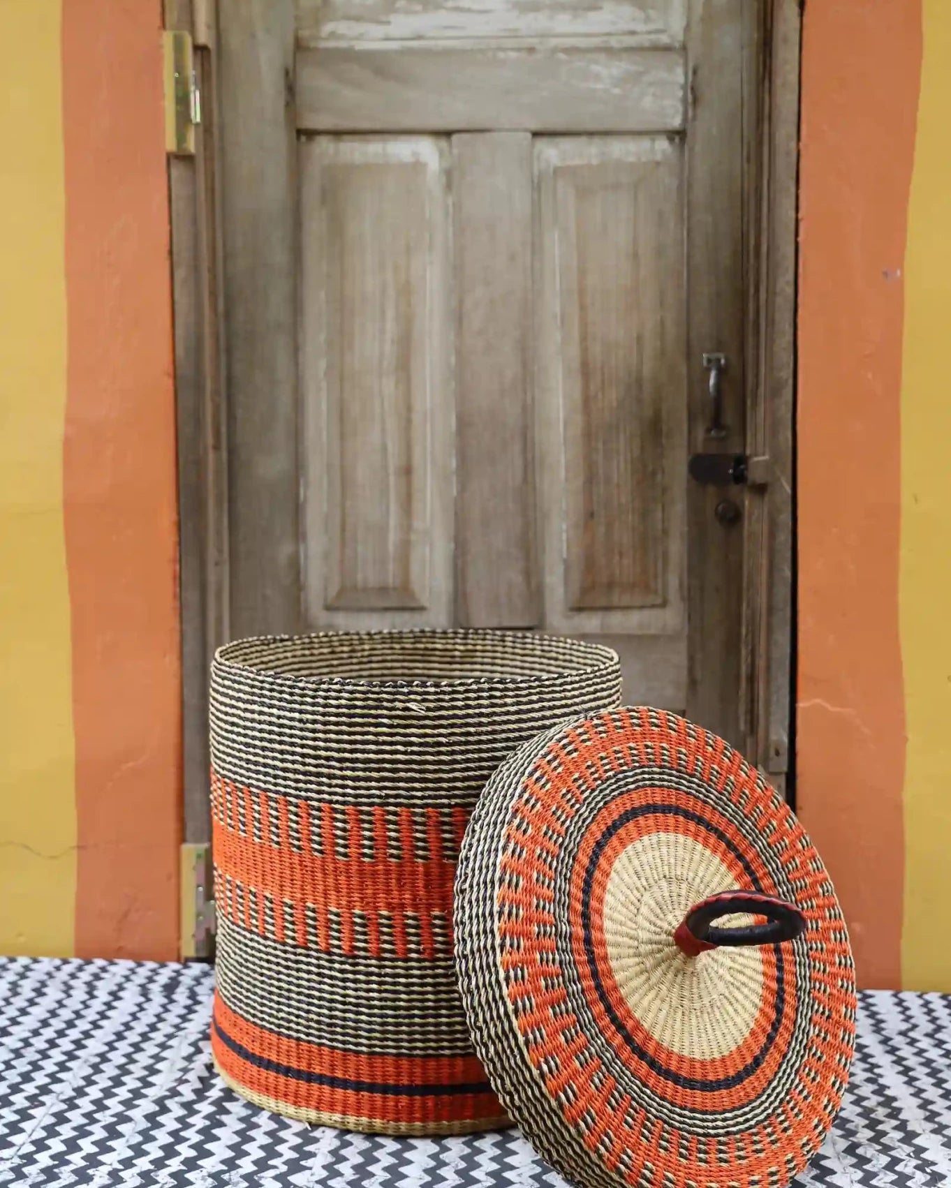 Lidded Laundry Basket (Large) by The Baba Tree. Handwoven elephant grass with leather handle. Premium Bolgatanga artisan decor.