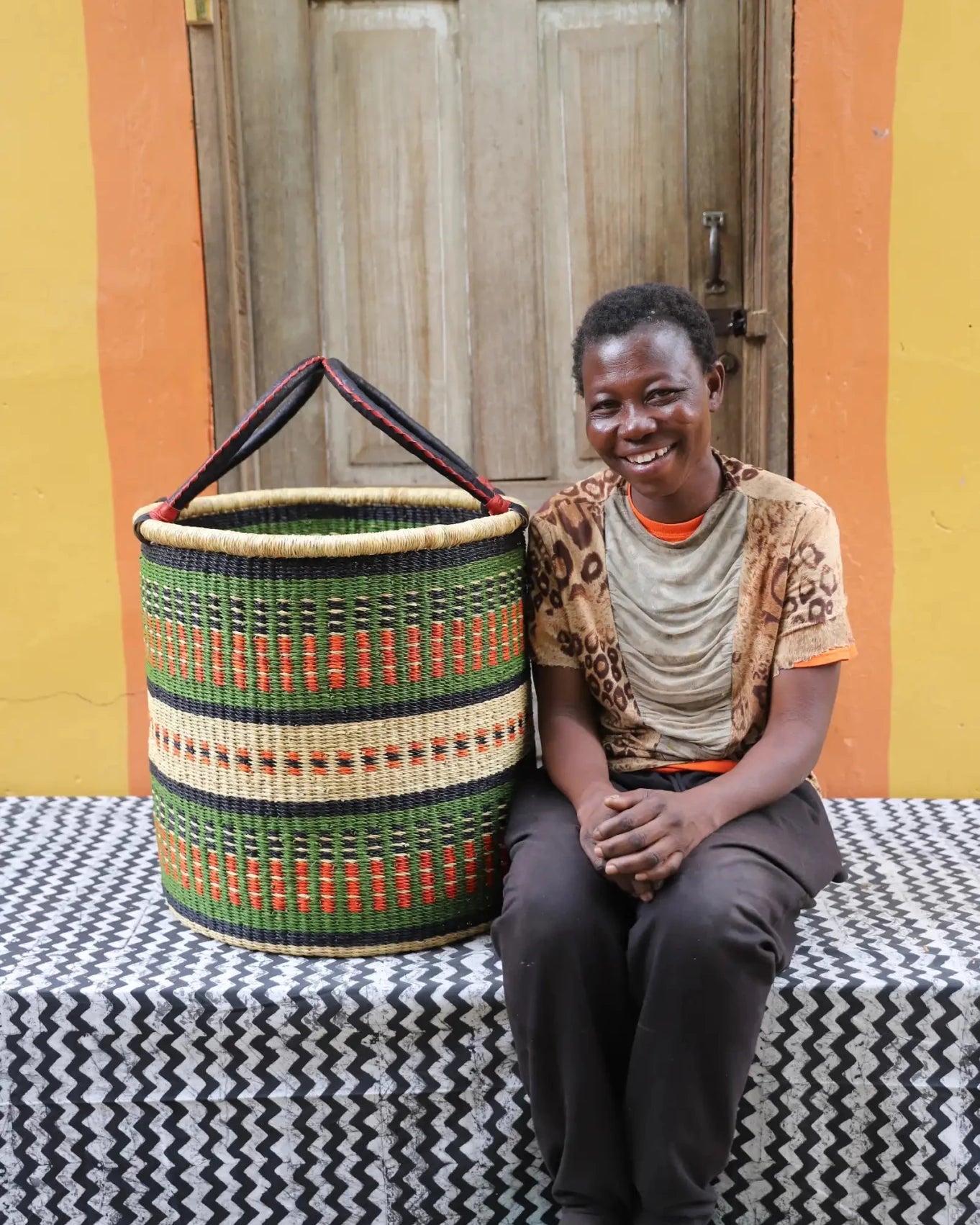 Open Laundry Basket (Large) by The Baba Tree. Handwoven elephant grass storage with leather handles. Bolgatanga artisan decor.