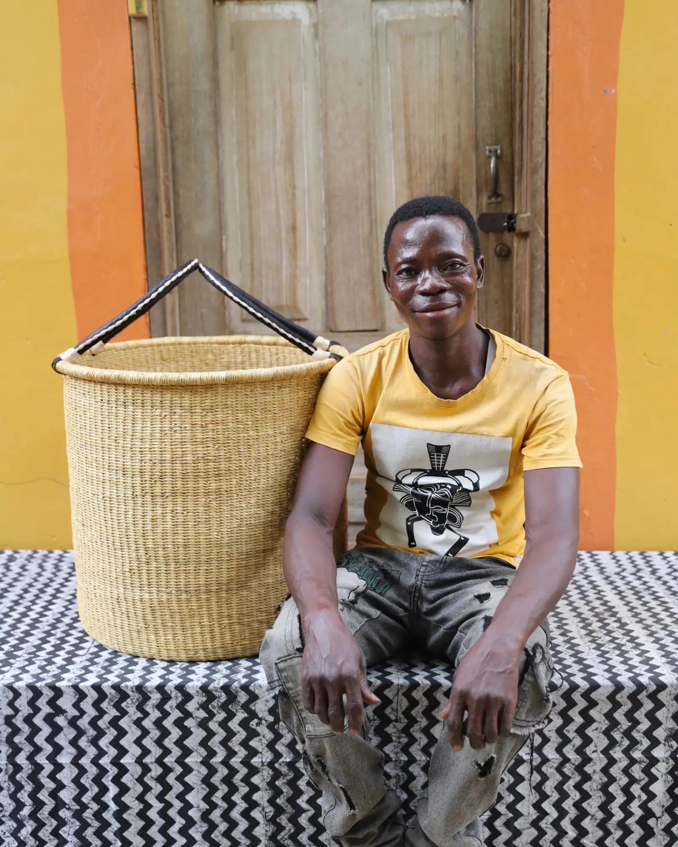 Open Laundry Basket (Large) by The Baba Tree. Handwoven elephant grass storage with leather handles. Bolgatanga artisan decor.