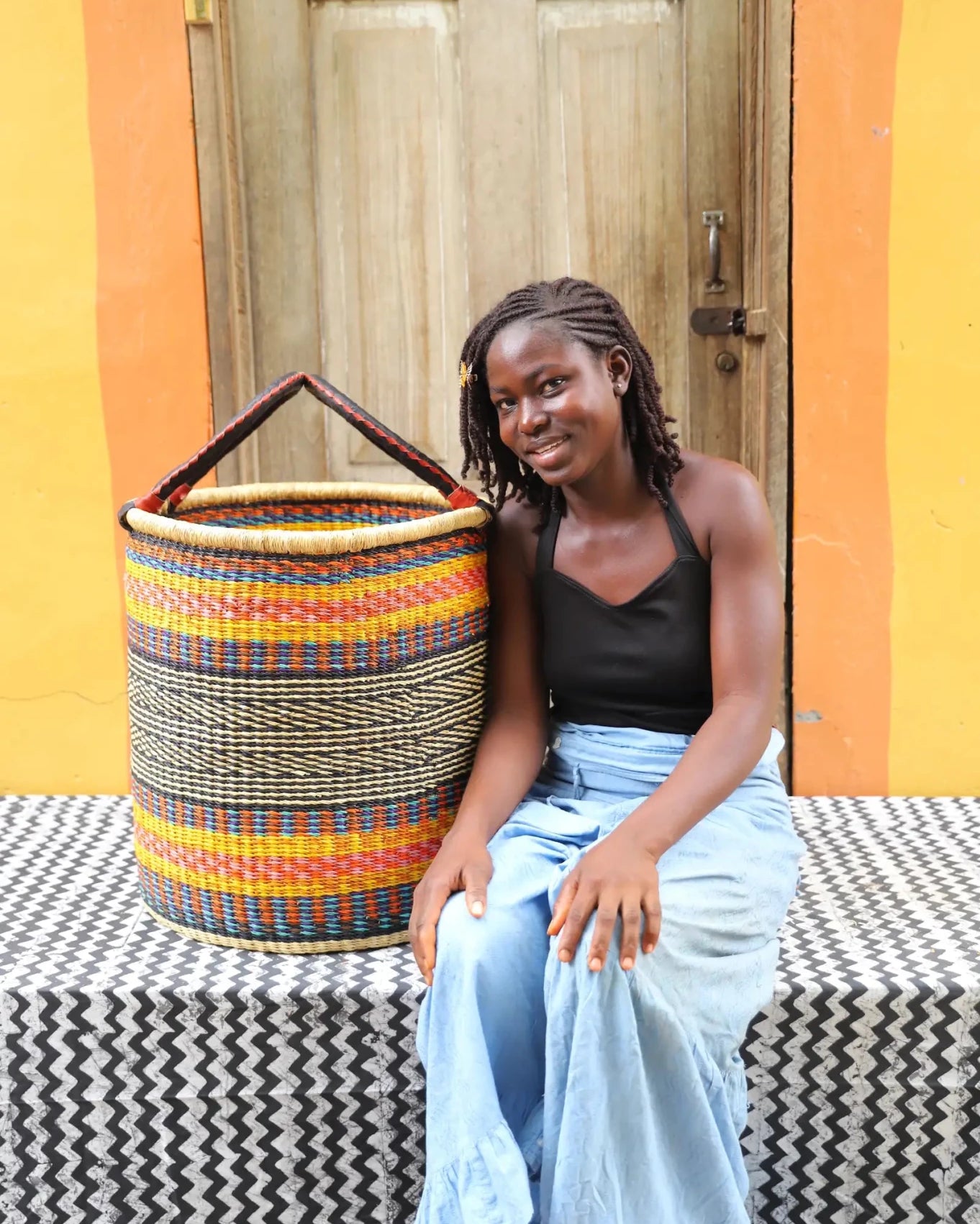 Open Laundry Basket (Large) by The Baba Tree. Handwoven elephant grass storage with leather handles. Bolgatanga artisan decor.