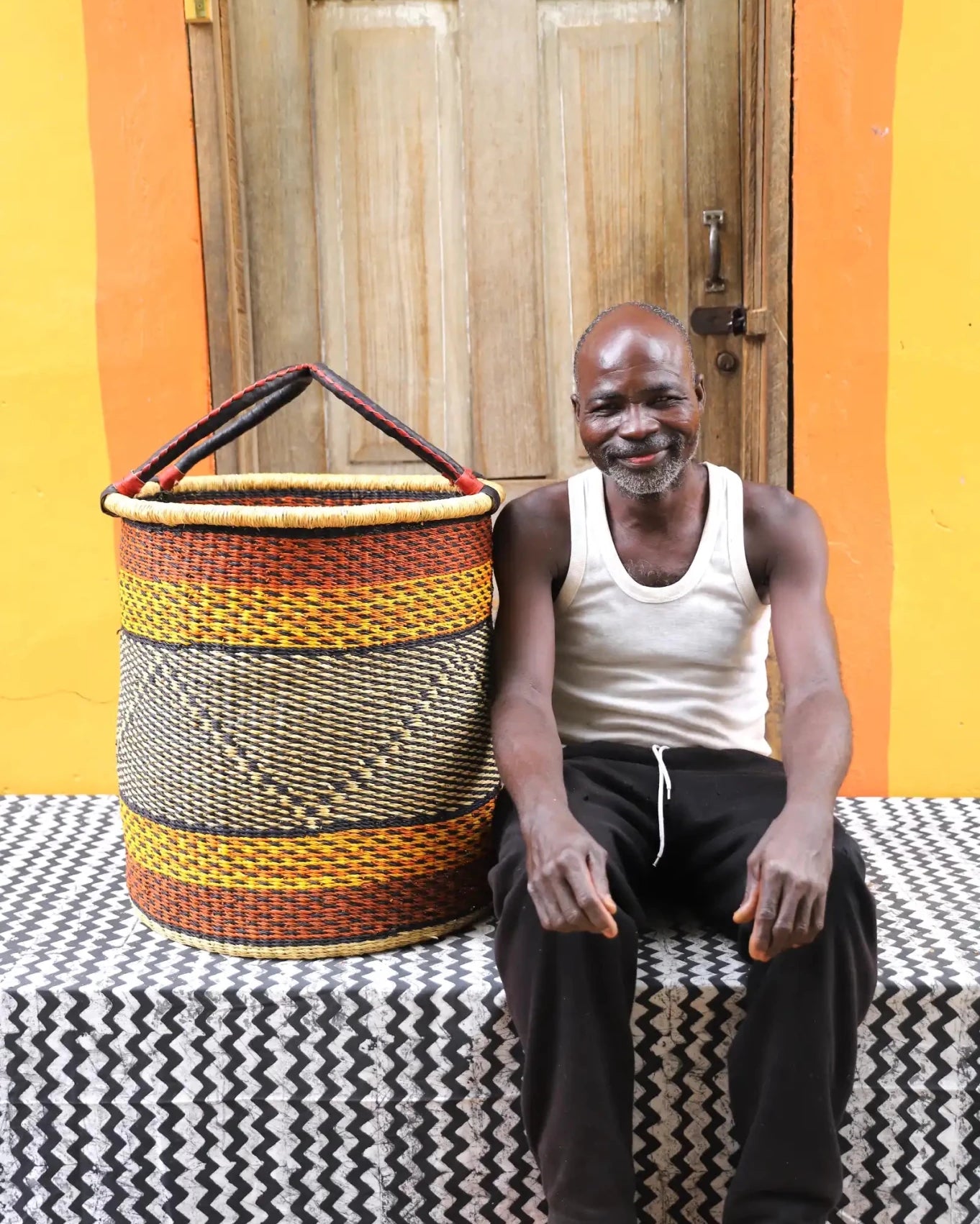 Open Laundry Basket (Large) by The Baba Tree. Handwoven elephant grass storage with leather handles. Bolgatanga artisan decor.