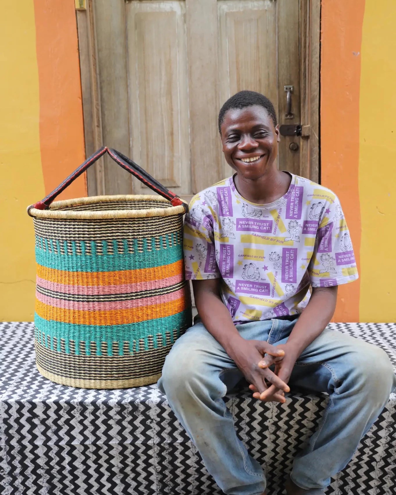 Open Laundry Basket (Large) by The Baba Tree. Handwoven elephant grass storage with leather handles. Bolgatanga artisan decor.