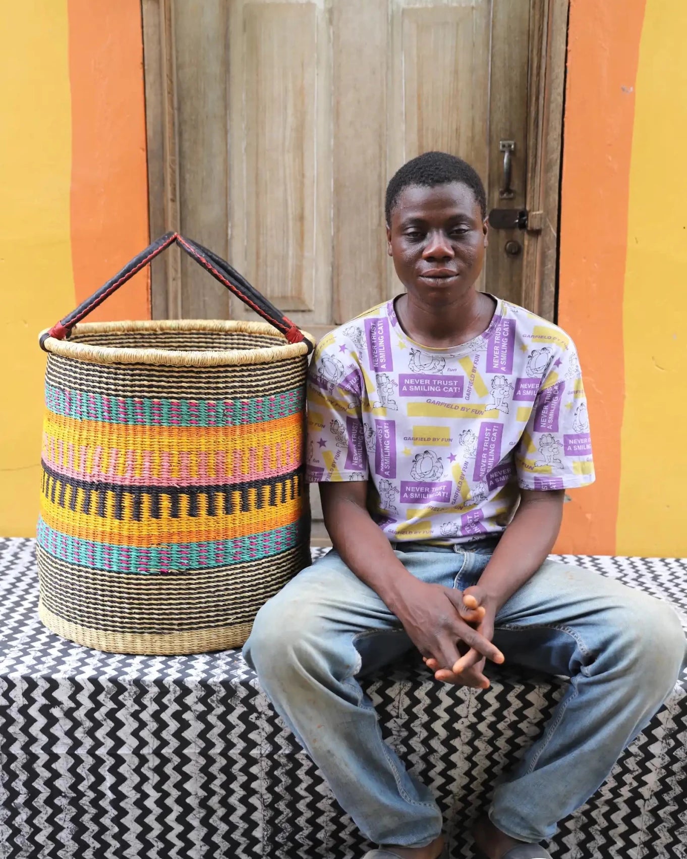 Open Laundry Basket (Large) by The Baba Tree. Handwoven elephant grass storage with leather handles. Bolgatanga artisan decor.