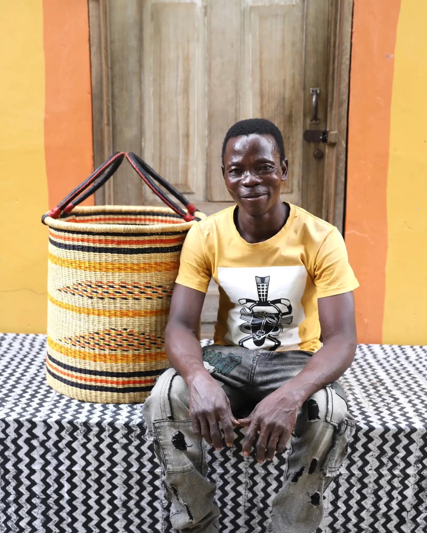 Open Laundry Basket (Medium) by The Baba Tree. Handwoven elephant grass storage with leather handles. Bolgatanga artisan decor.