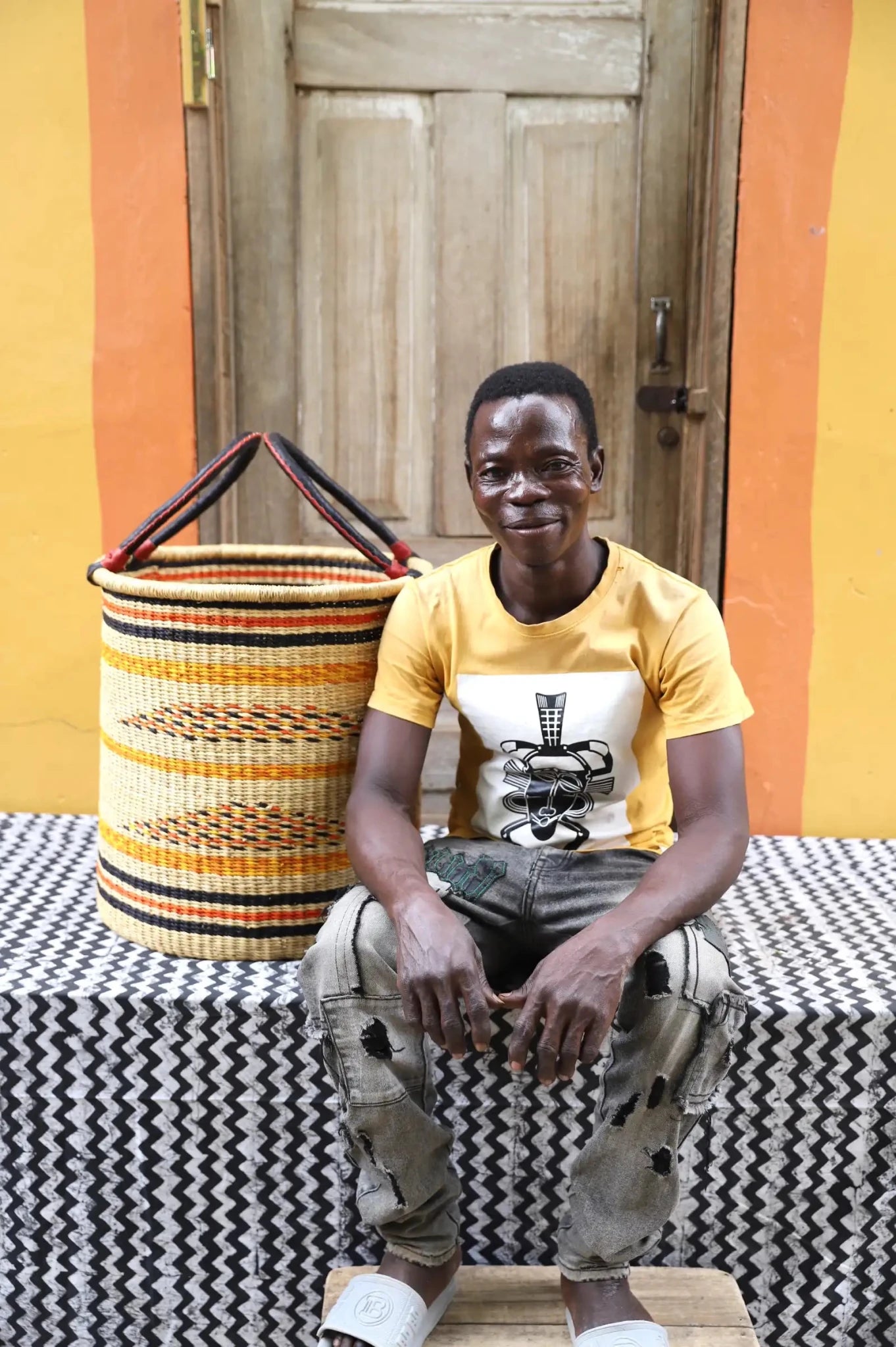 Open Laundry Basket (Medium) by The Baba Tree. Handwoven elephant grass storage with leather handles. Bolgatanga artisan decor.