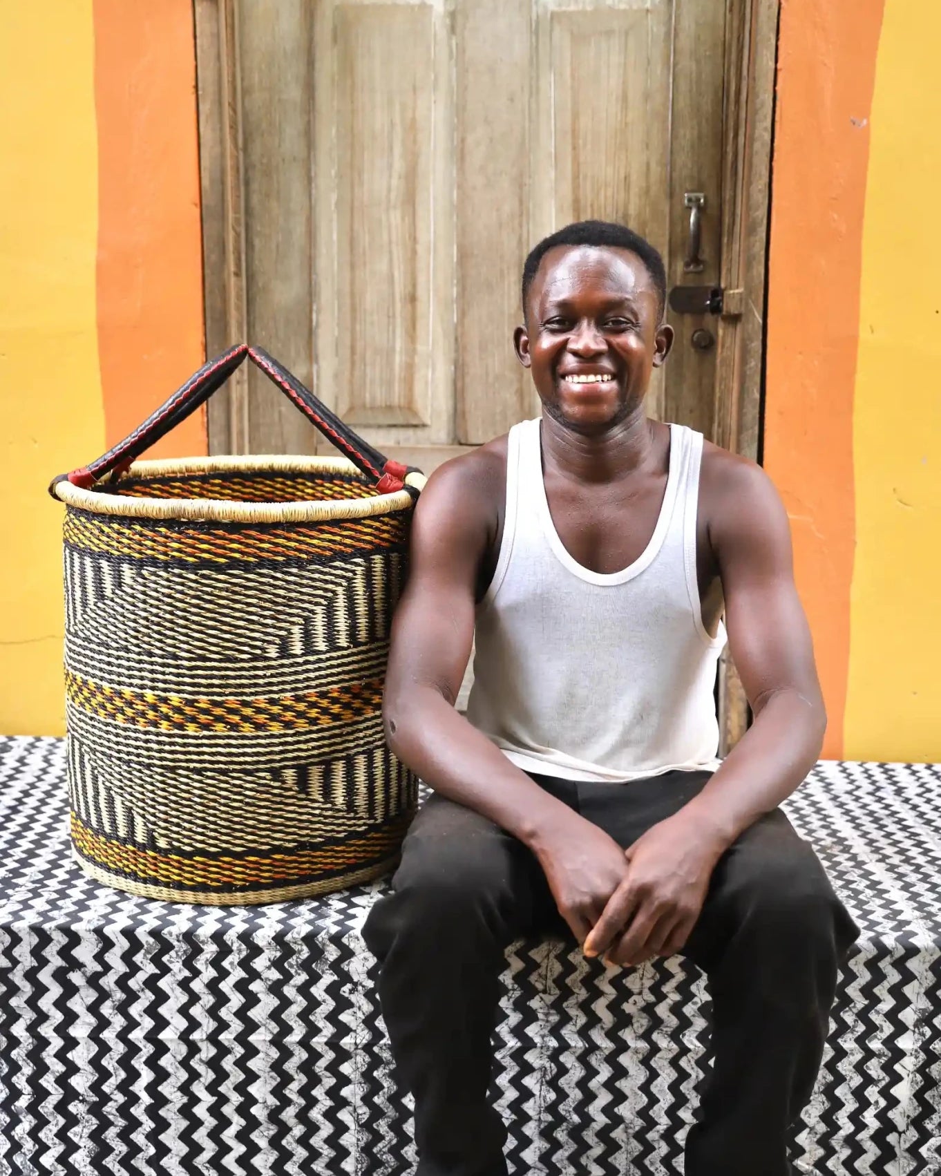 Open Laundry Basket (Medium) by The Baba Tree. Handwoven elephant grass storage with leather handles. Bolgatanga artisan decor.