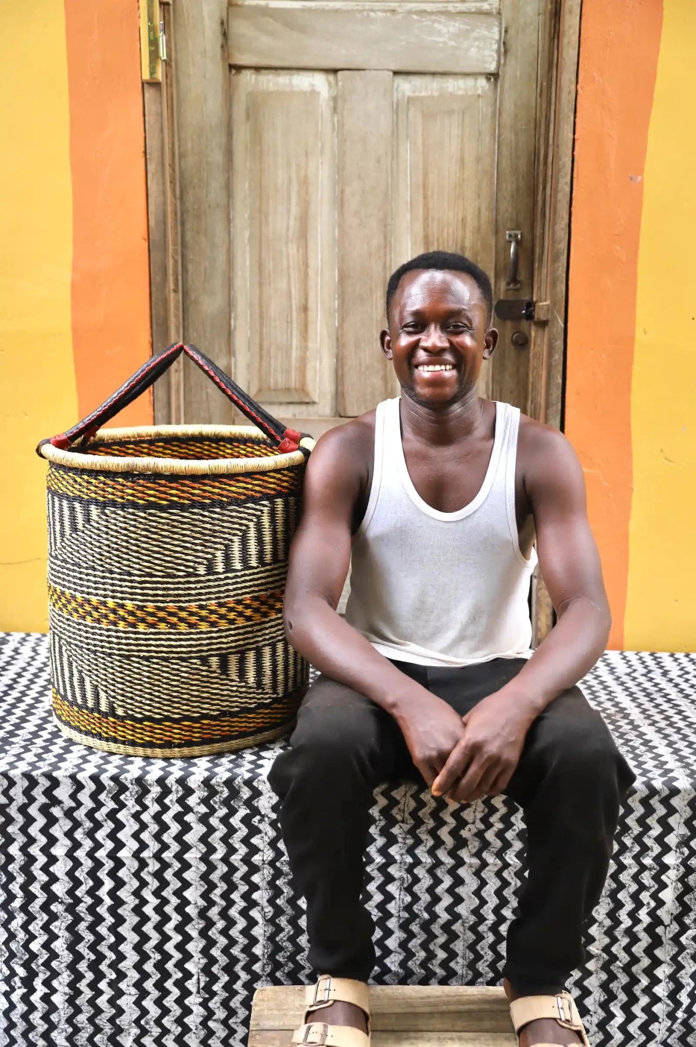 Open Laundry Basket (Medium) by The Baba Tree. Handwoven elephant grass storage with leather handles. Bolgatanga artisan decor.