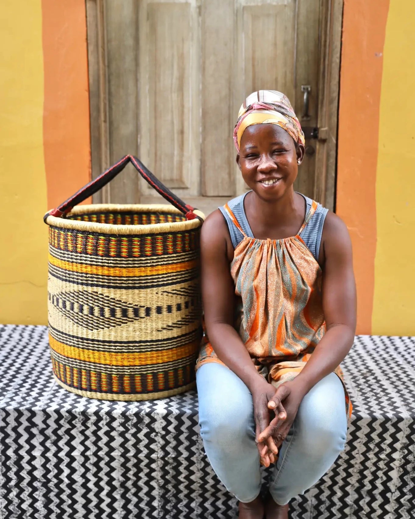 Open Laundry Basket (Medium) by The Baba Tree. Handwoven elephant grass storage with leather handles. Bolgatanga artisan decor.