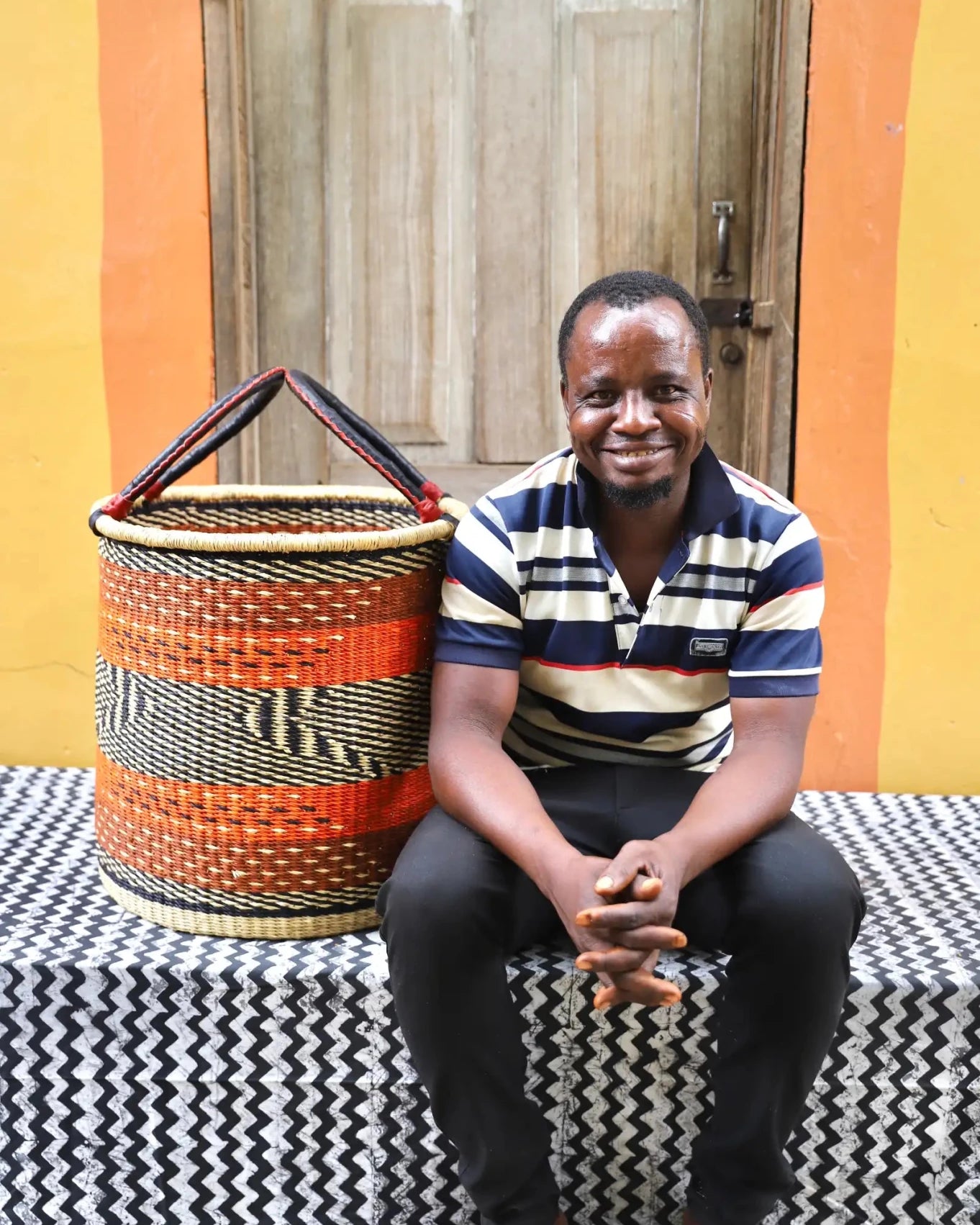 Open Laundry Basket (Medium) by The Baba Tree. Handwoven elephant grass storage with leather handles. Bolgatanga artisan decor.