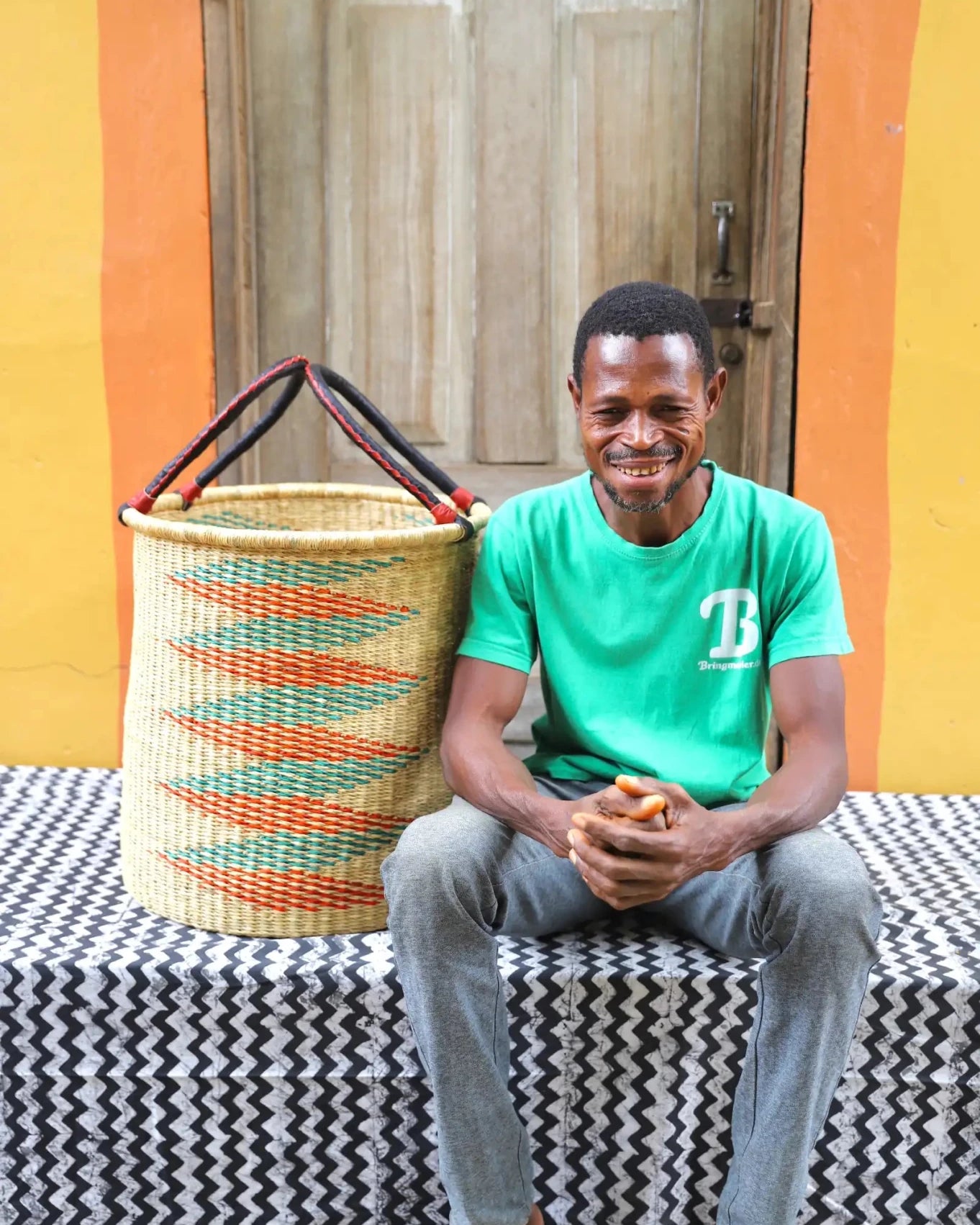 Open Laundry Basket (Medium) by The Baba Tree. Handwoven elephant grass storage with leather handles. Bolgatanga artisan decor.