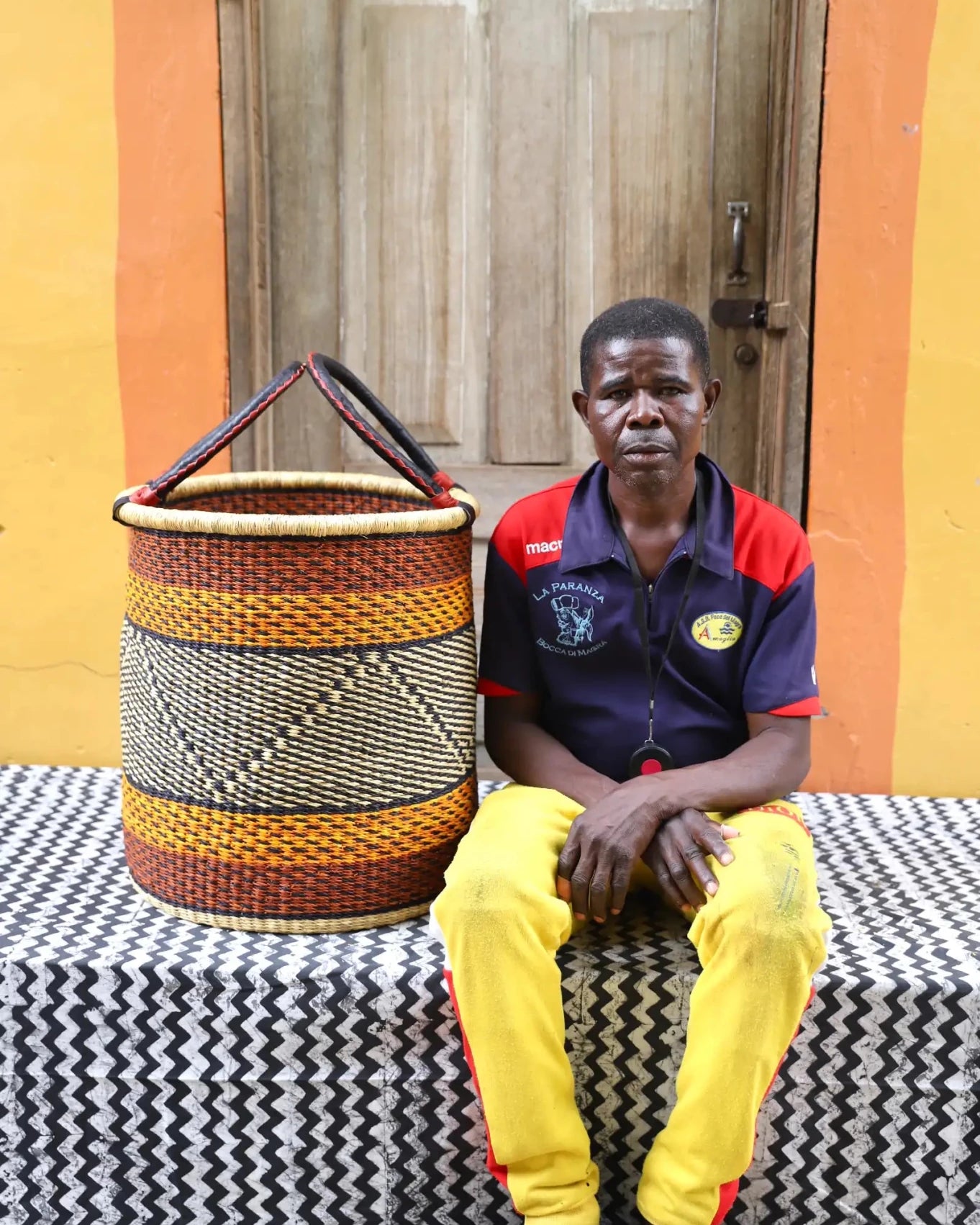 Open Laundry Basket (Medium) by The Baba Tree. Handwoven elephant grass storage with leather handles. Bolgatanga artisan decor.