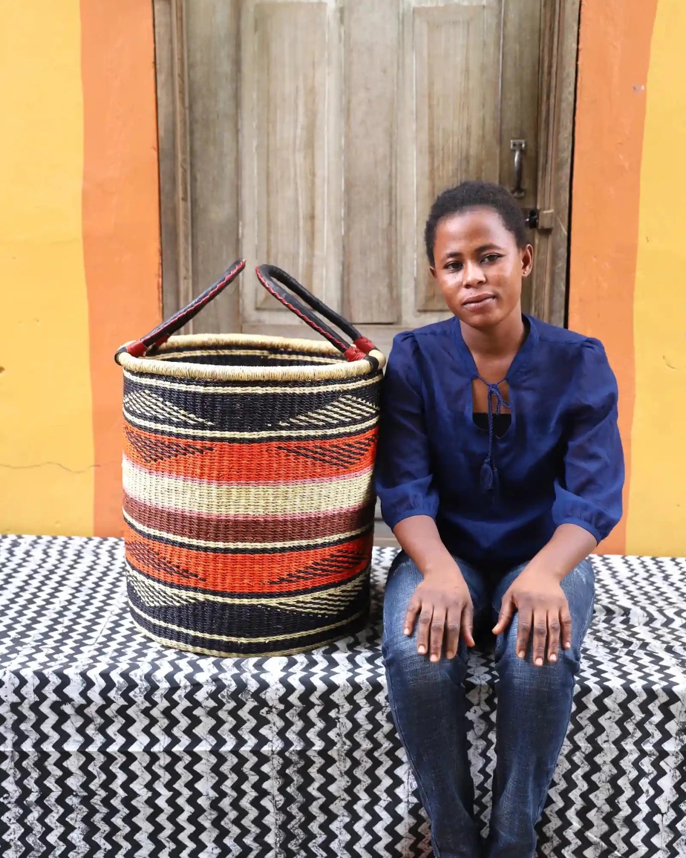 Open Laundry Basket (Medium) by The Baba Tree. Handwoven elephant grass storage with leather handles. Bolgatanga artisan decor.