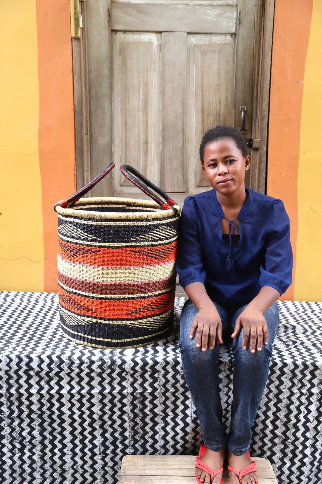 Open Laundry Basket (Medium) by The Baba Tree. Handwoven elephant grass storage with leather handles. Bolgatanga artisan decor.