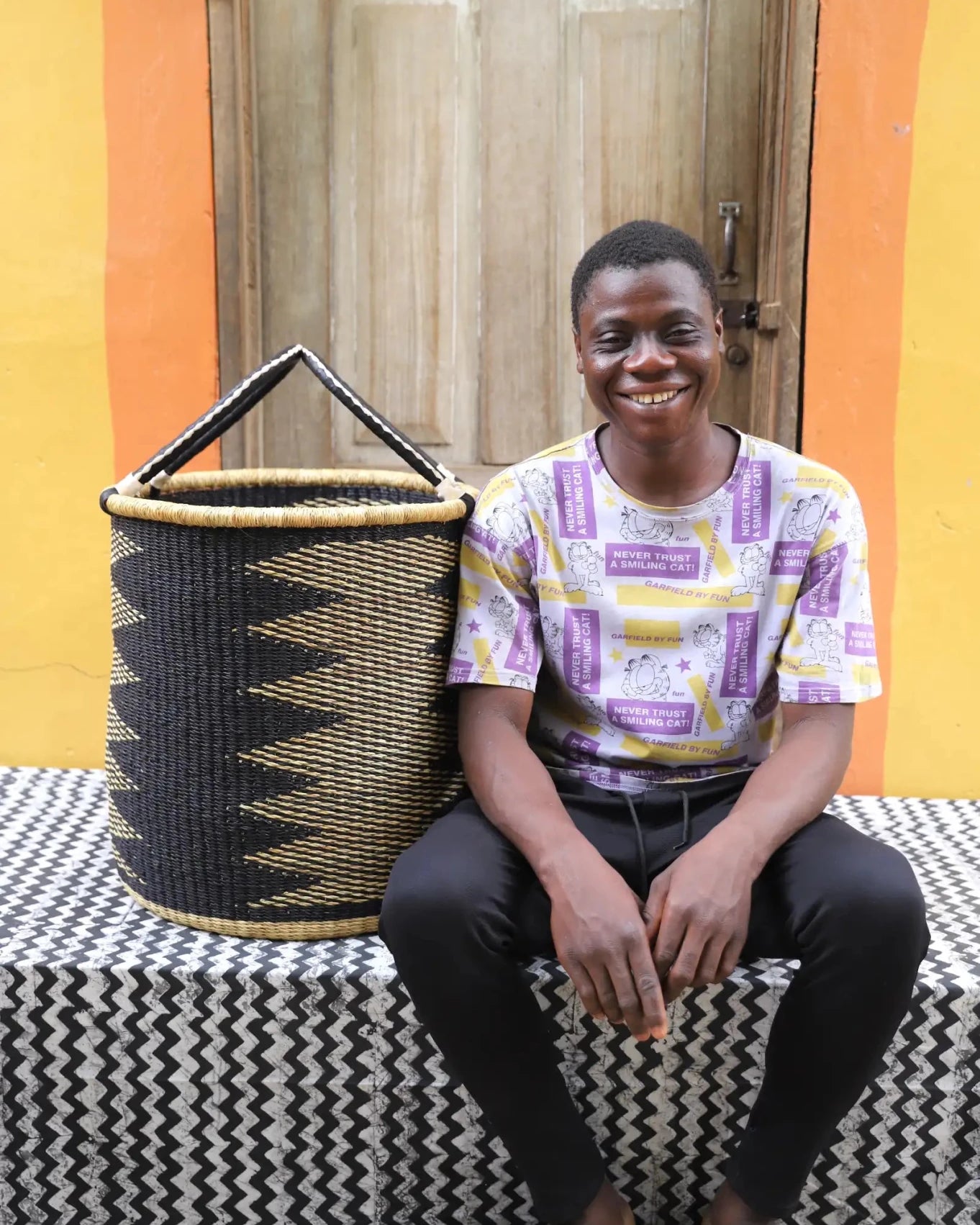 Open Laundry Basket (Medium) by The Baba Tree. Handwoven elephant grass storage with leather handles. Bolgatanga artisan decor.