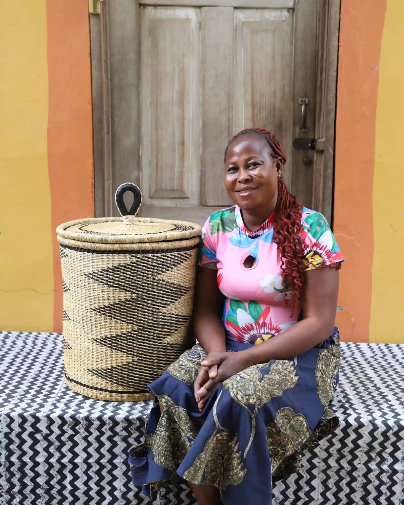 Lidded Laundry Basket with coil (Small) by The Baba Tree. Handwoven elephant grass with leather handle. Premium Bolgatanga artisan decor.
