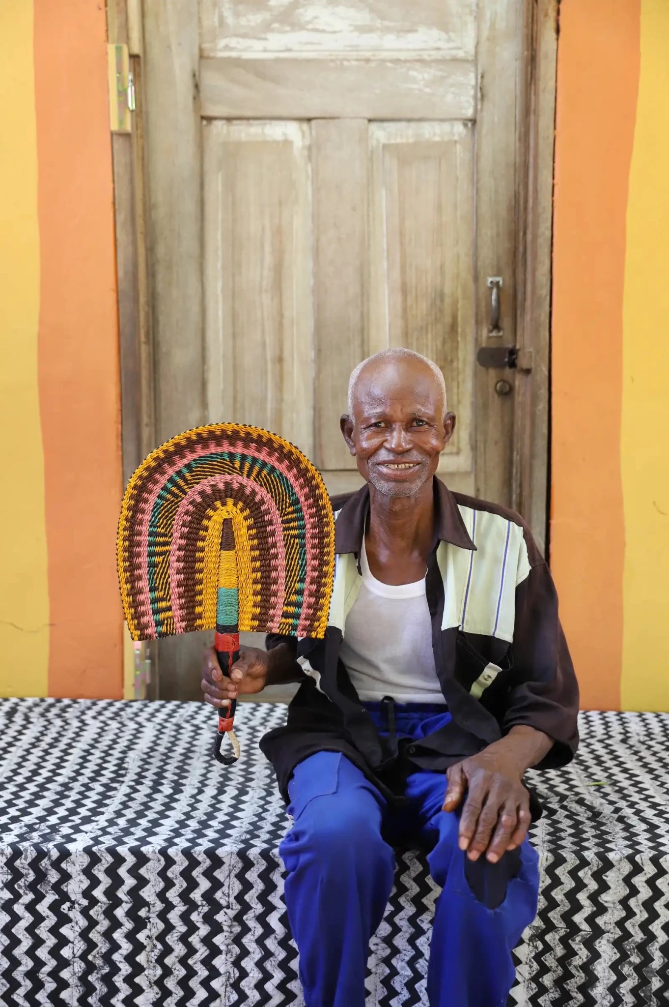 The Baba Tree Bolga Original Fan: Handwoven architectural wall art with intricate weave and premium leather handle.