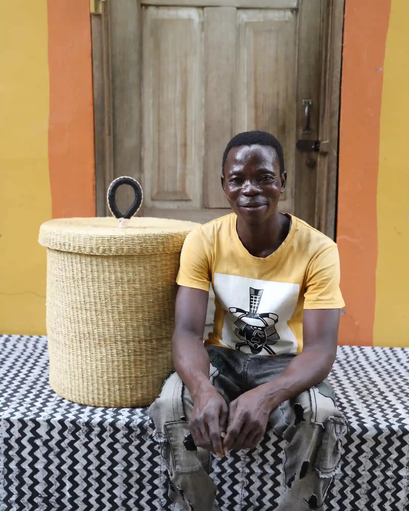 Lidded Laundry Basket (Medium) by The Baba Tree. Handwoven elephant grass with leather handle. Premium Bolgatanga artisan decor.l