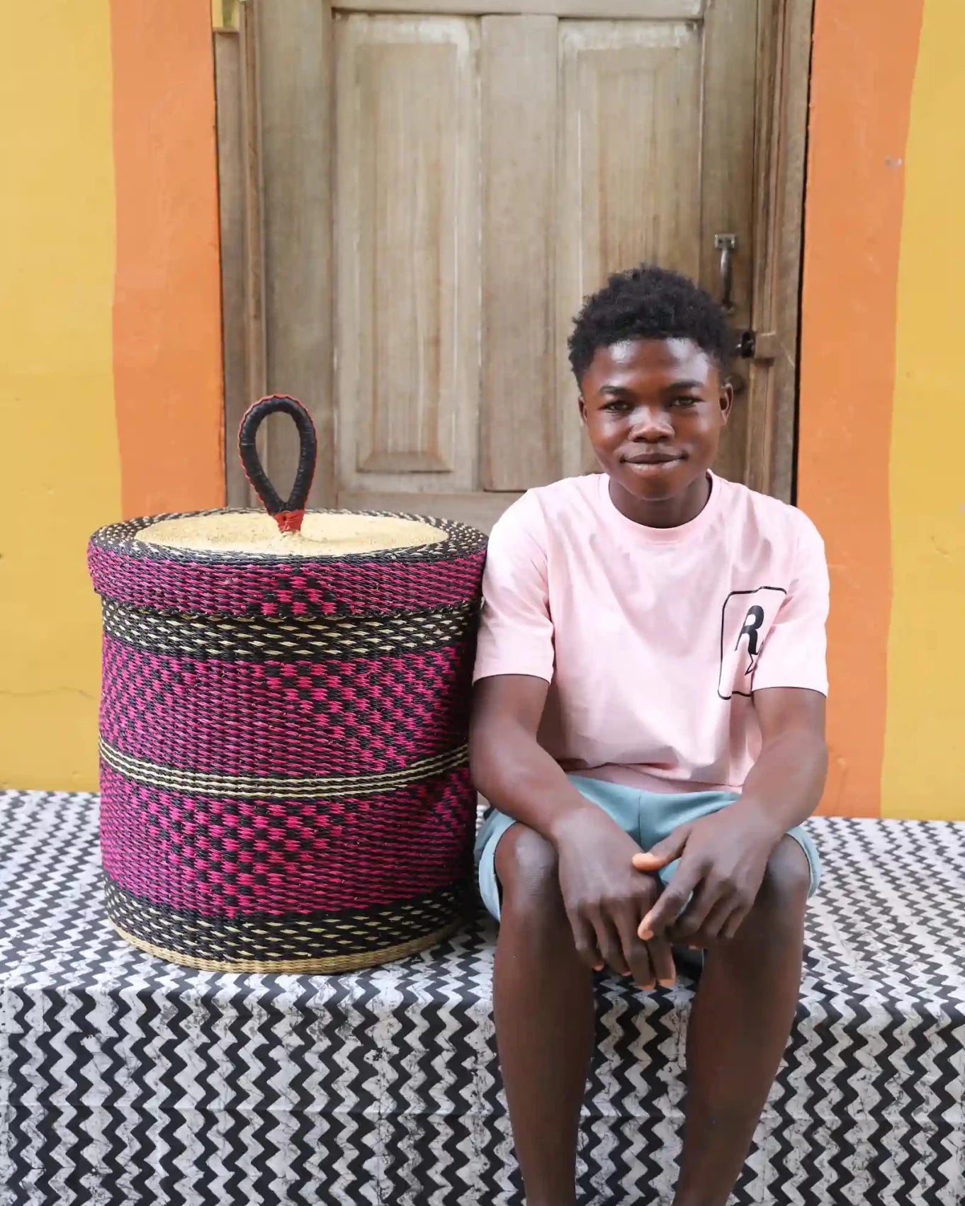 Lidded Laundry Basket (Medium) by The Baba Tree. Handwoven elephant grass with leather handle. Premium Bolgatanga artisan decor.l
