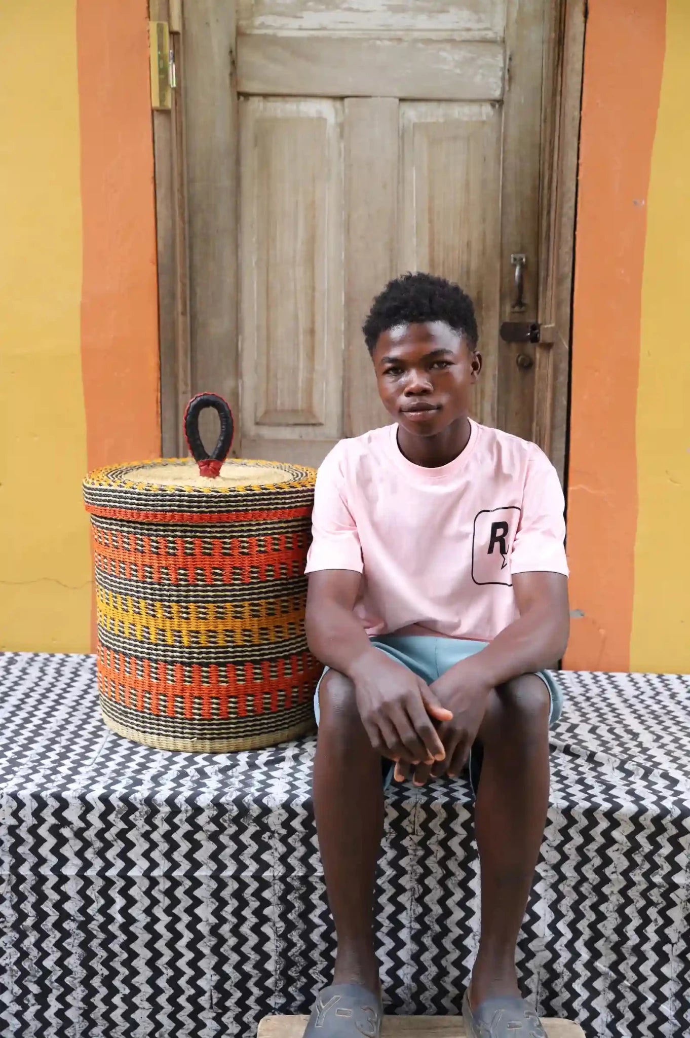 Lidded Laundry Basket (Small) by The Baba Tree. Handwoven elephant grass
with leather handle. Premium Bolgatanga artisan decor.