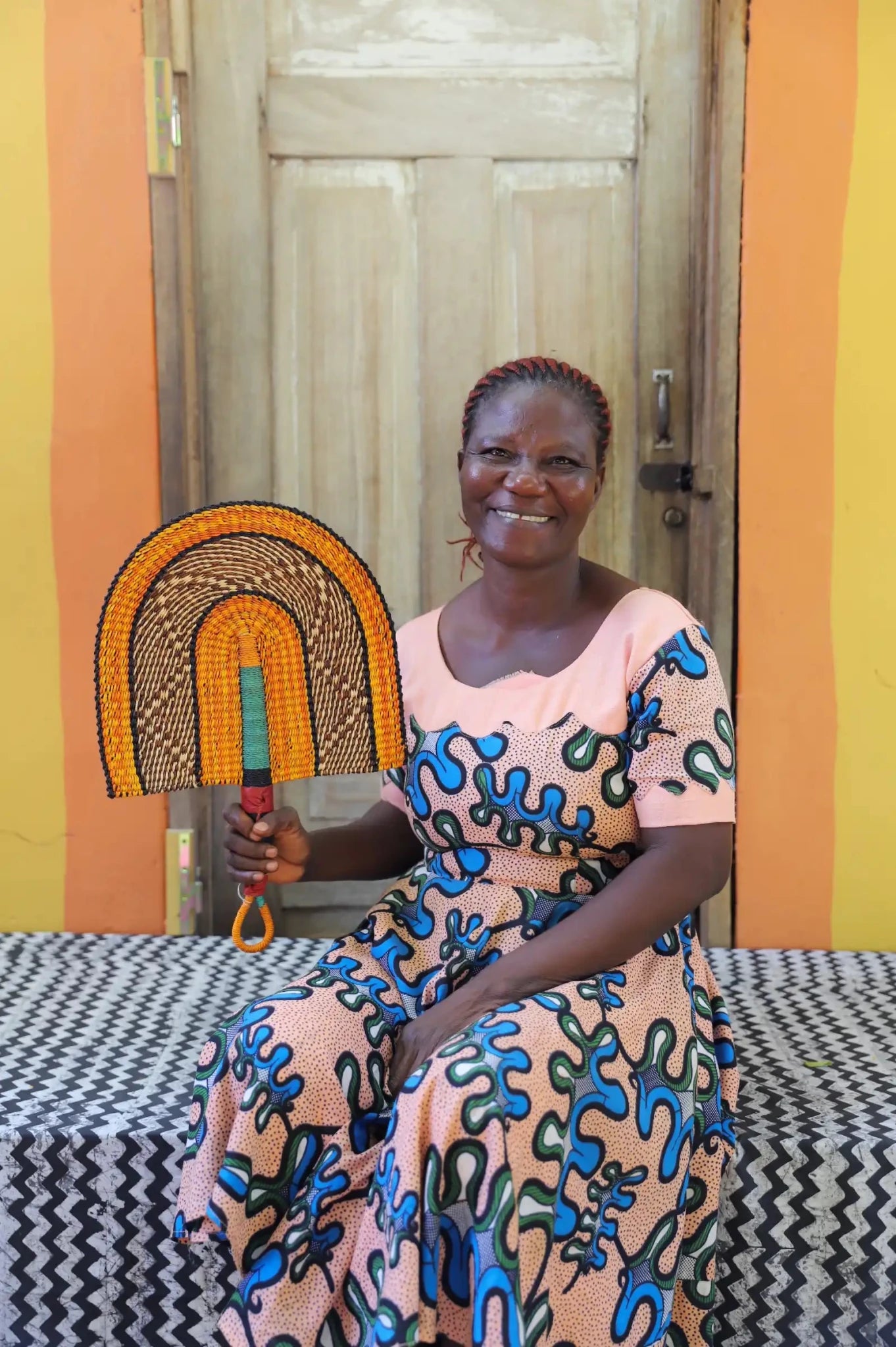 The Baba Tree Bolga Original Fan: Handwoven architectural wall art with intricate weave and premium leather handle.