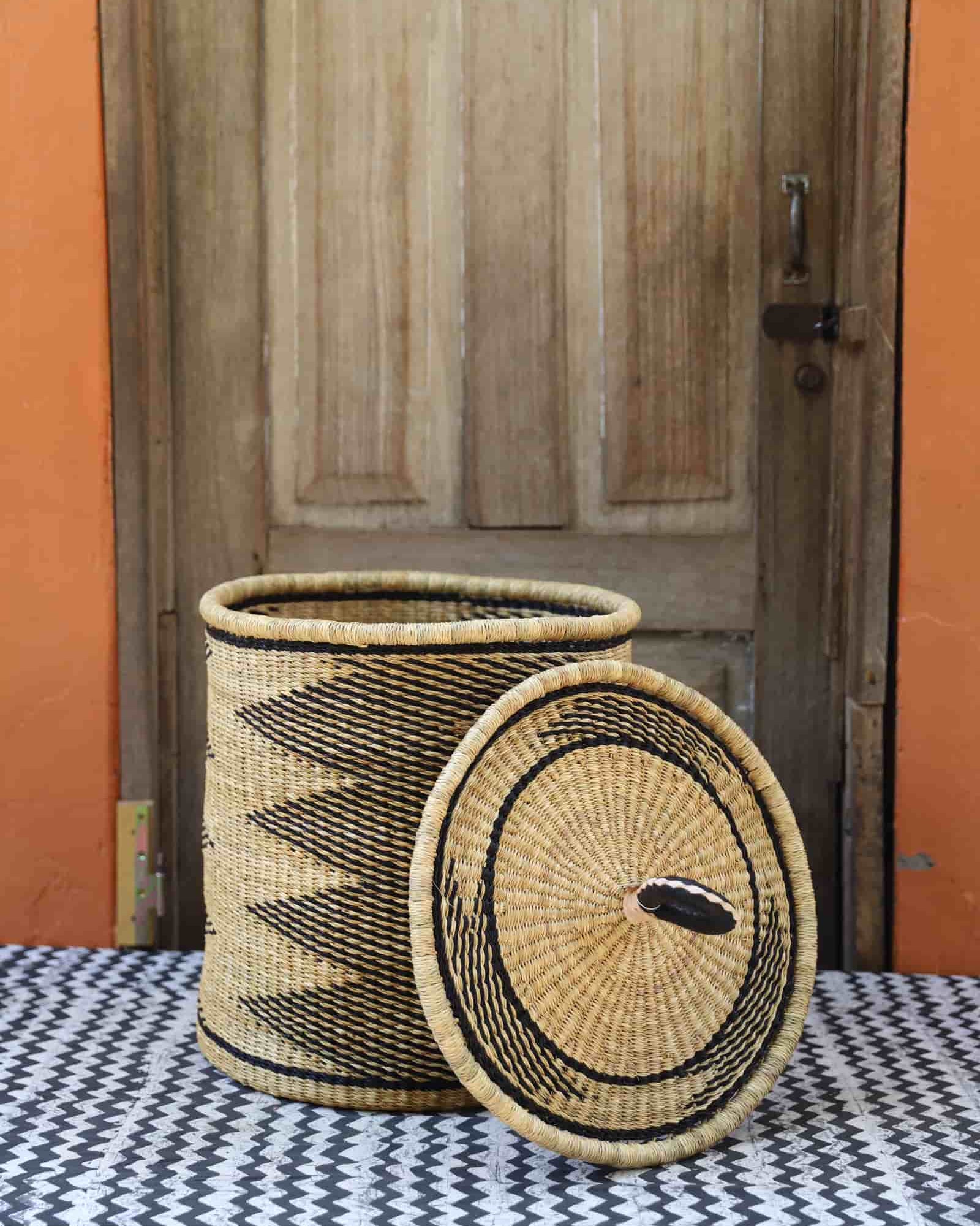 Lidded Laundry Basket with coil (Small) by The Baba Tree. Handwoven elephant grass with leather handle. Premium Bolgatanga artisan decor.