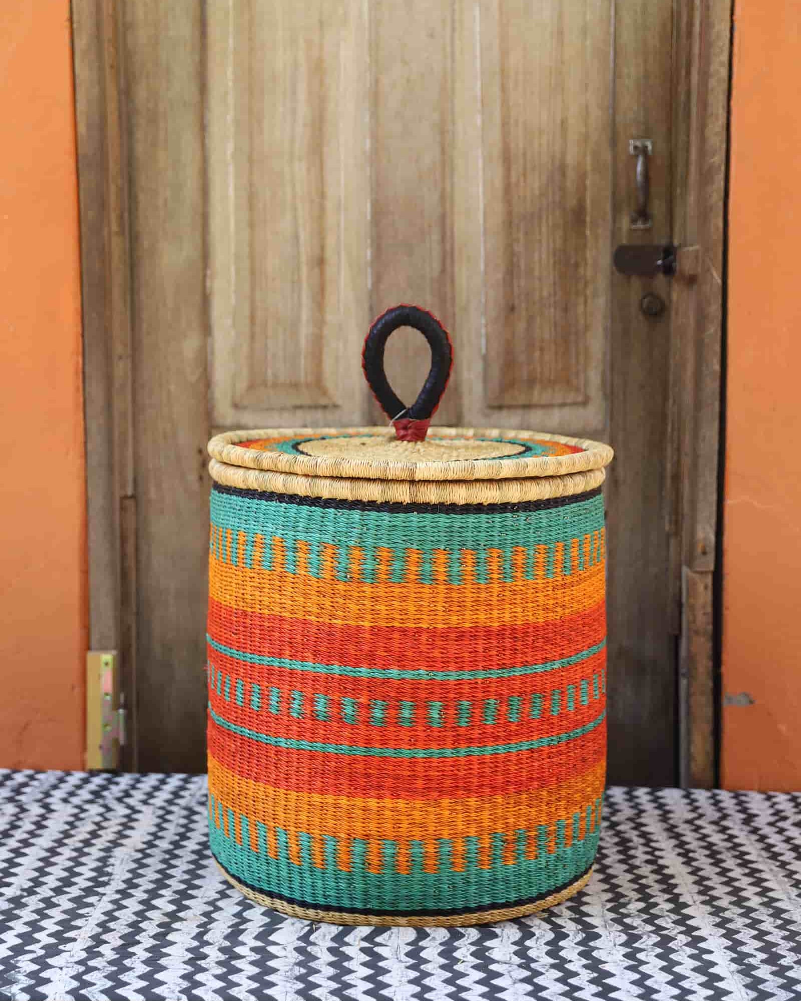 Lidded Laundry Basket with coil (Medium) by The Baba Tree. Handwoven elephant grass with leather handle. Premium Bolgatanga artisan decor.