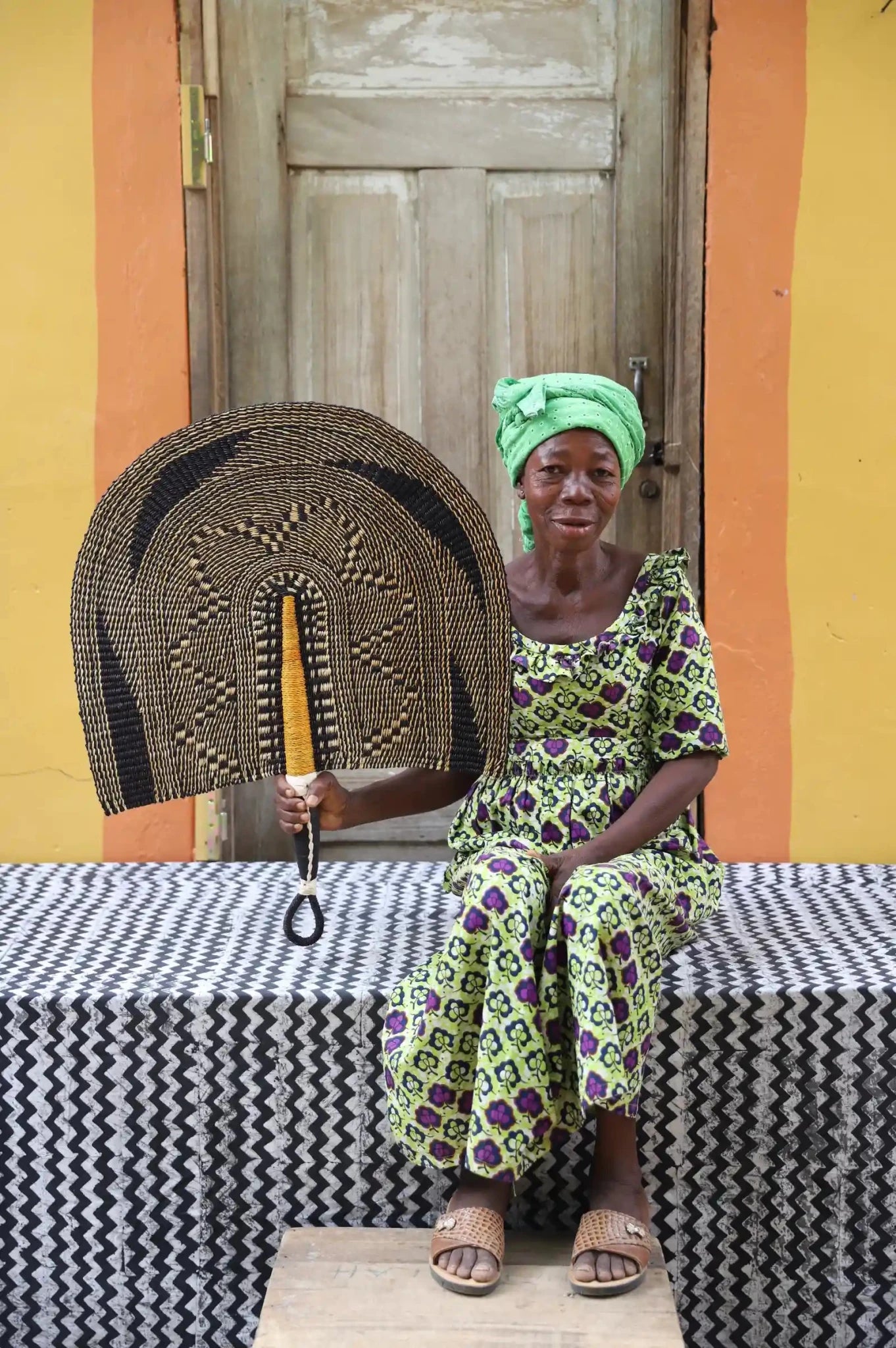 Naba Pengo Fan by The Baba Tree. Premium handwoven elephant grass wall art and artisanal Bolgatanga home decor.