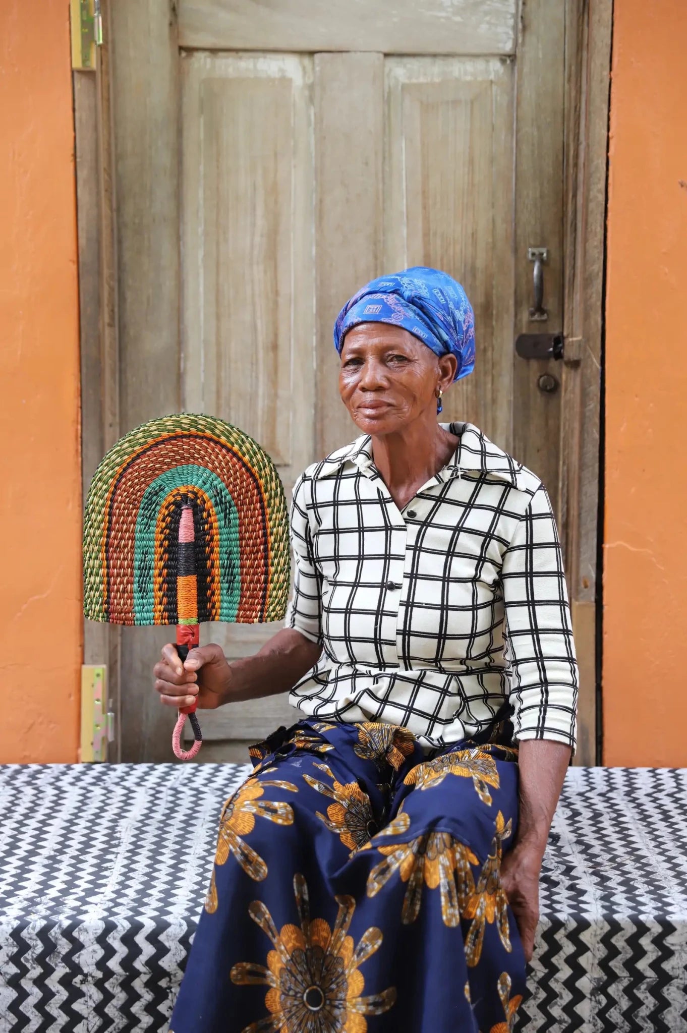 The Baba Tree Bolga Original Fan: Handwoven architectural wall art with intricate weave and premium leather handle.