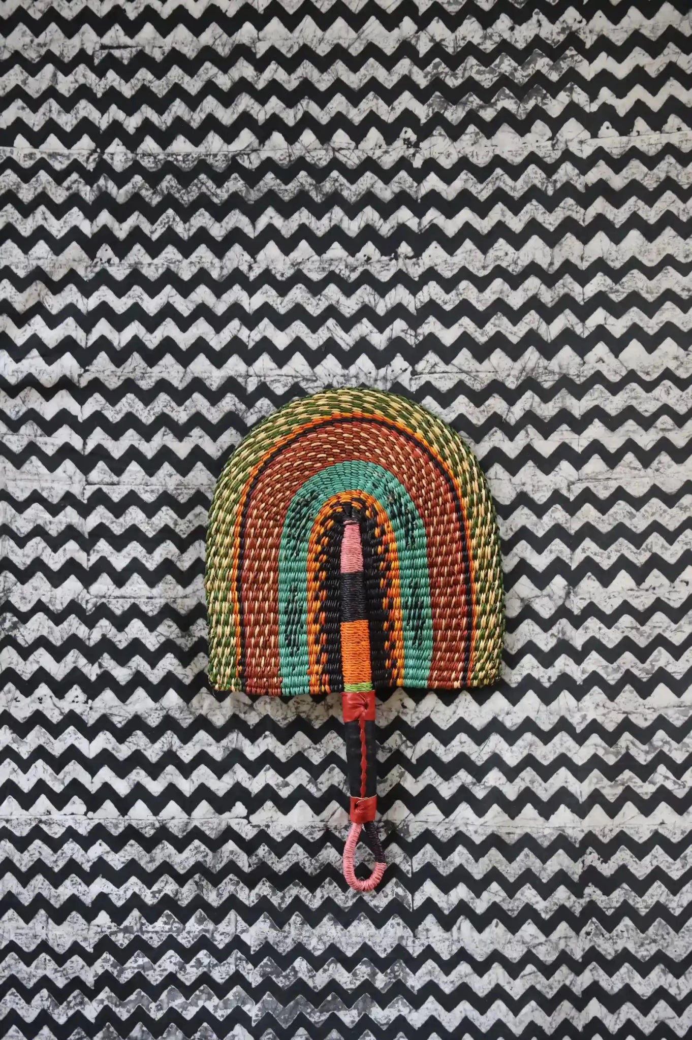 The Baba Tree Bolga Original Fan: Handwoven architectural wall art with intricate weave and premium leather handle.