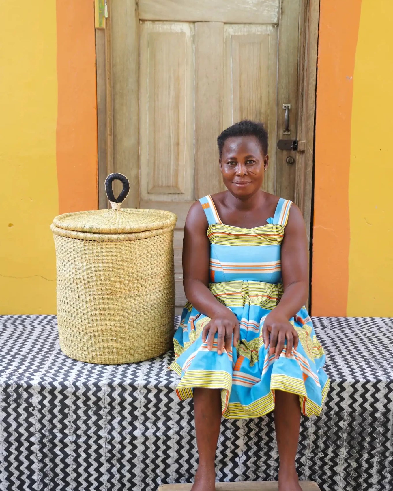 Lidded Laundry Basket with coil (Small) by The Baba Tree. Handwoven elephant grass with leather handle. Premium Bolgatanga artisan decor.