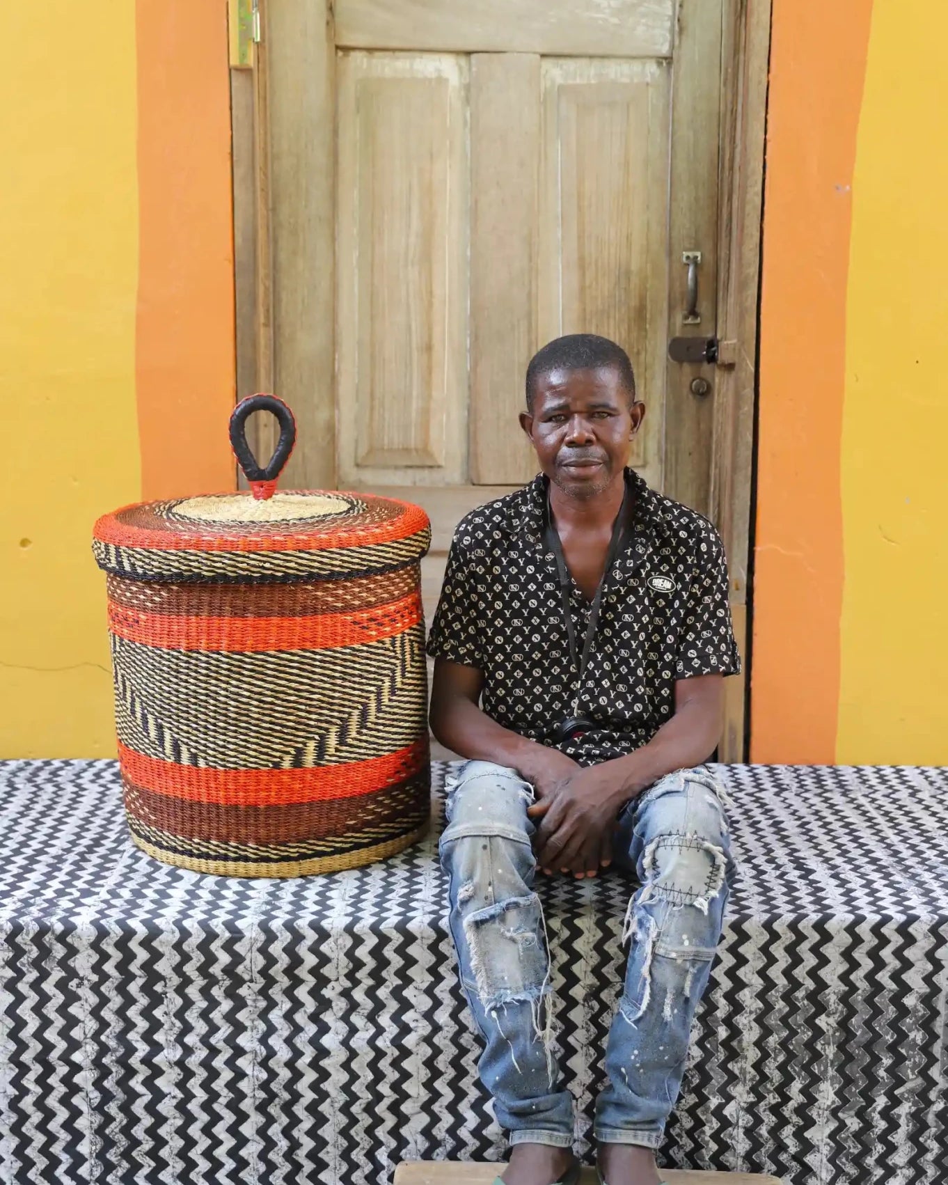 Lidded Laundry Basket (Medium) by The Baba Tree. Handwoven elephant grass with leather handle. Premium Bolgatanga artisan decor.