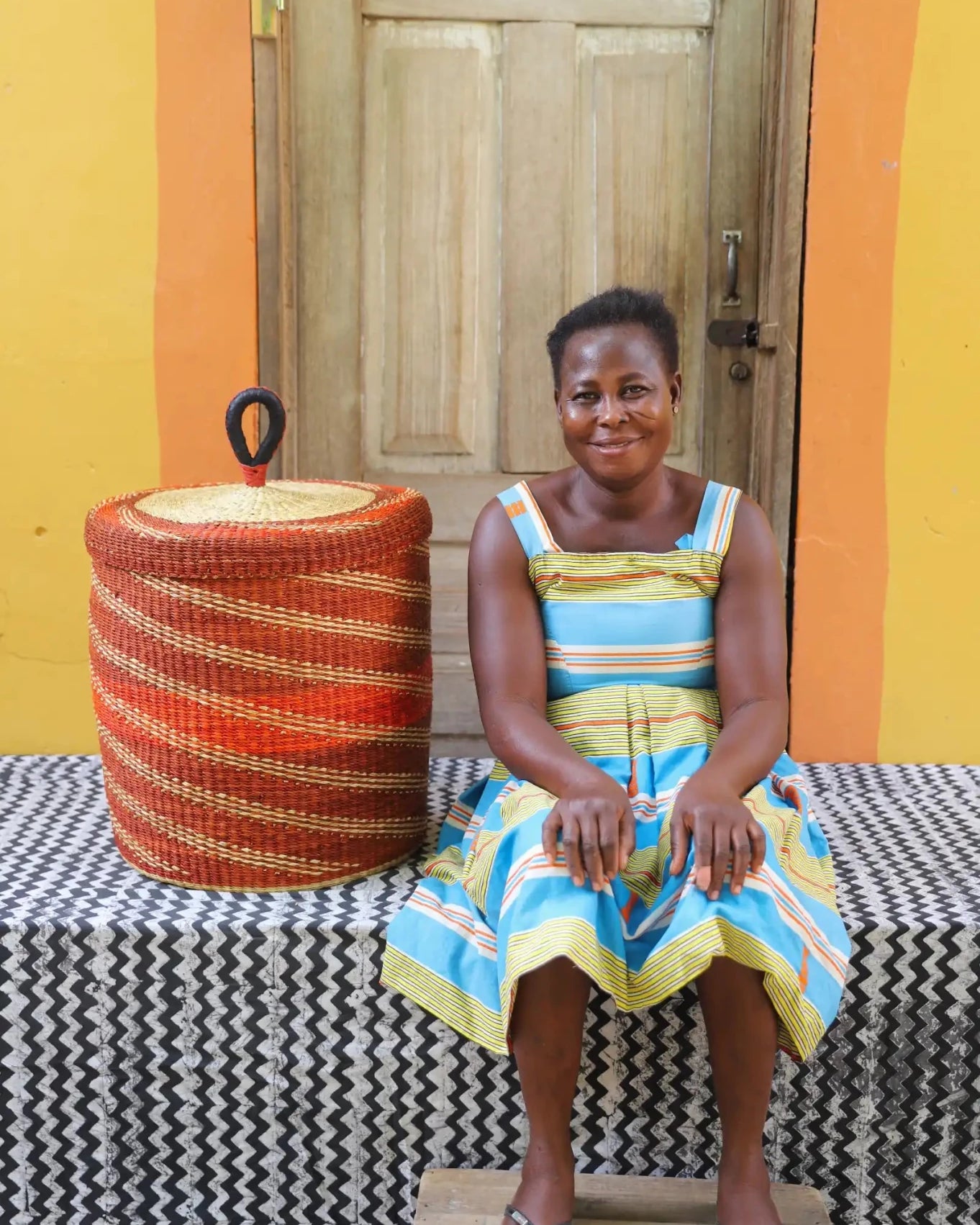 Lidded Laundry Basket (Medium) by The Baba Tree. Handwoven elephant grass with leather handle. Premium Bolgatanga artisan decor.